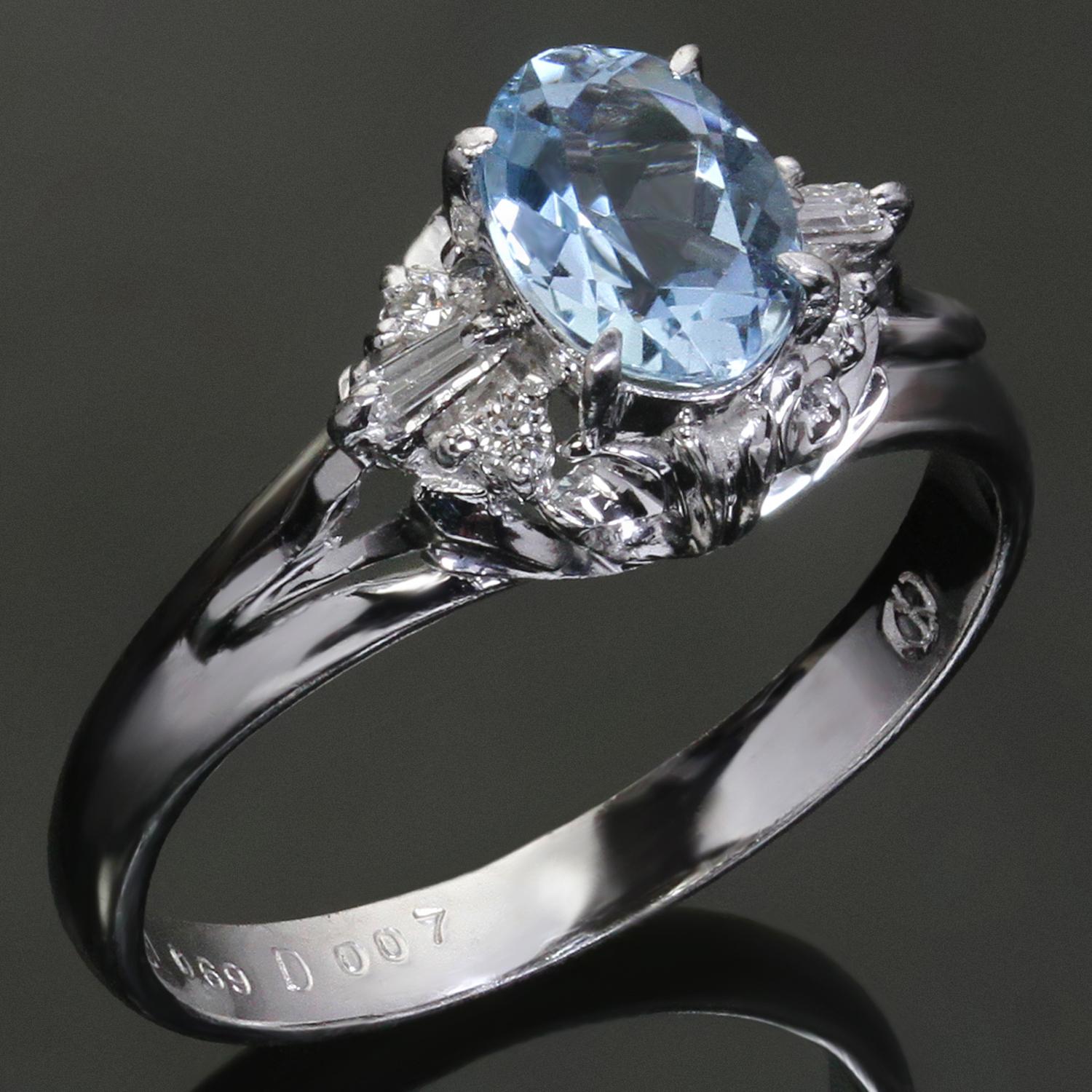 This stunning estate cocktail ring is crafted in platinum and features a sparkling bright blue oval aquamarine gemstone weighing an estimated 0.69 carats, surrounded by round diamonds weighing an estimated 0.07 carats. Made in United States circa