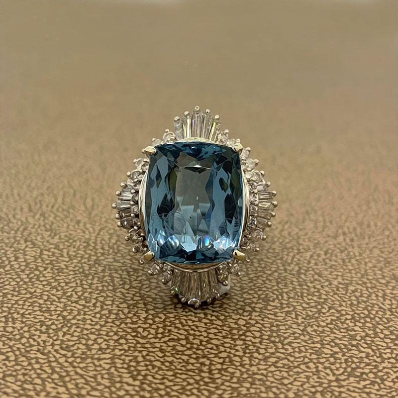 A magnificent ring featuring a 12.93 carat aquamarine with a luscious sea blue color. The gemstone is virtually flawless with no visible inclusions. It is accented by 2.01 carats of VS quality diamonds, round and baguette cuts. All hand fabricated