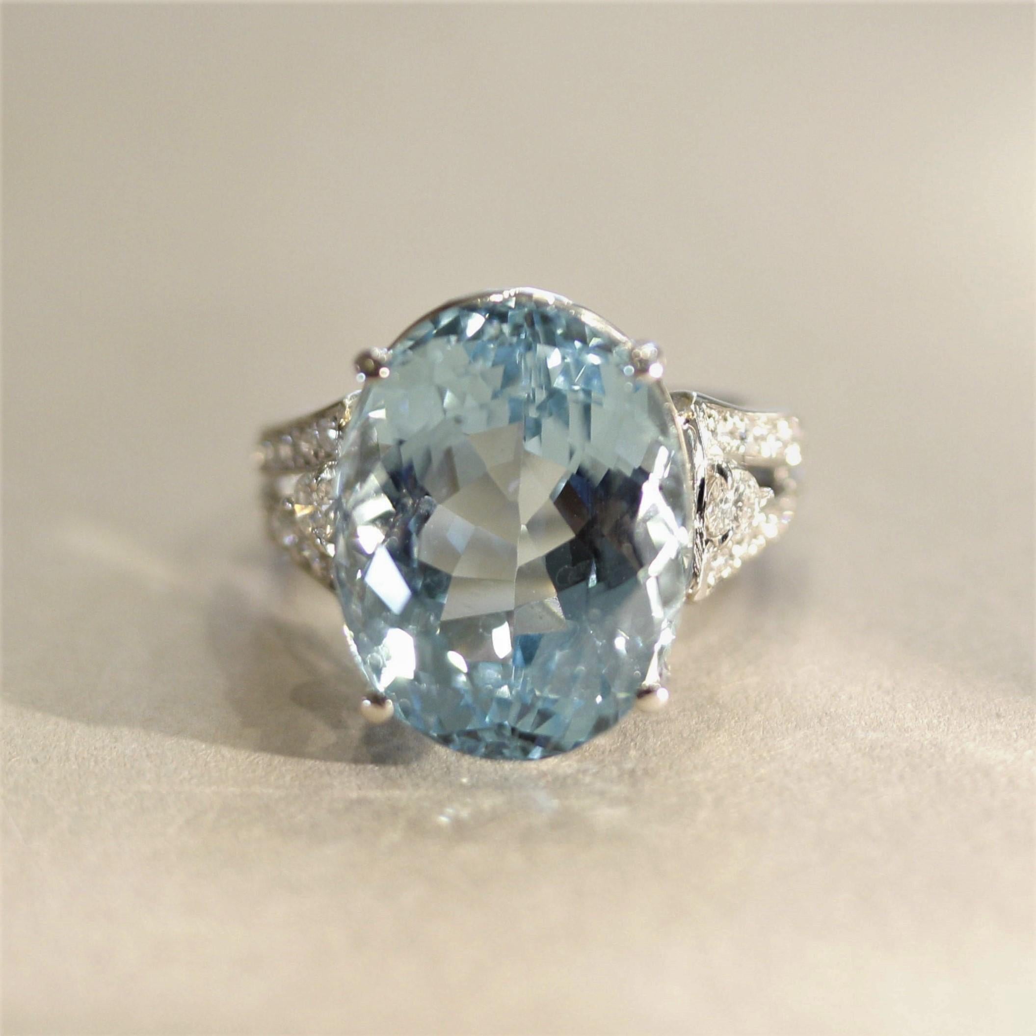 A special ring hand-fabricated in platinum, featuring a 13.73 carat oval-shape aquamarine! It has a lovely sea-blue color with excellent brilliance and light return. It is accented by 0.32 carats of round brilliant-cut diamonds which add light and