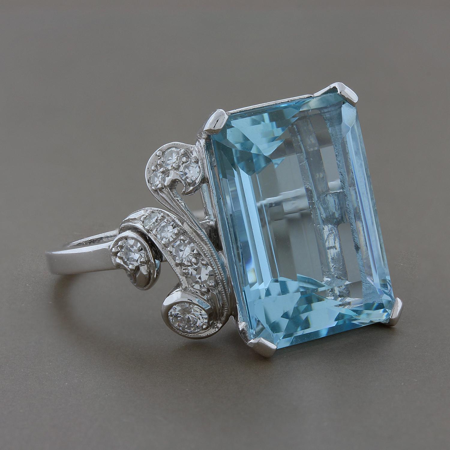 A lovely cocktail ring featuring a 12.48 carat aquamarine set in a platinum mounting. There are 0.30 carats of round cut diamonds accenting the emerald cut aquamarine, set in platinum.
Size 7 ¾ 
