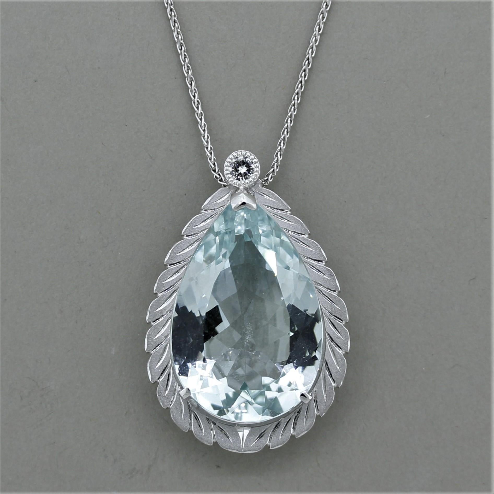 A lovely pendant featuring a 32.85 carat pear-shaped aquamarine! It has a classic sea-blue color and is free from any eye-visible inclusions. It is accented by a round brilliant-cut diamond set above it and weighing 0.17 carats. Hand-fabricated in