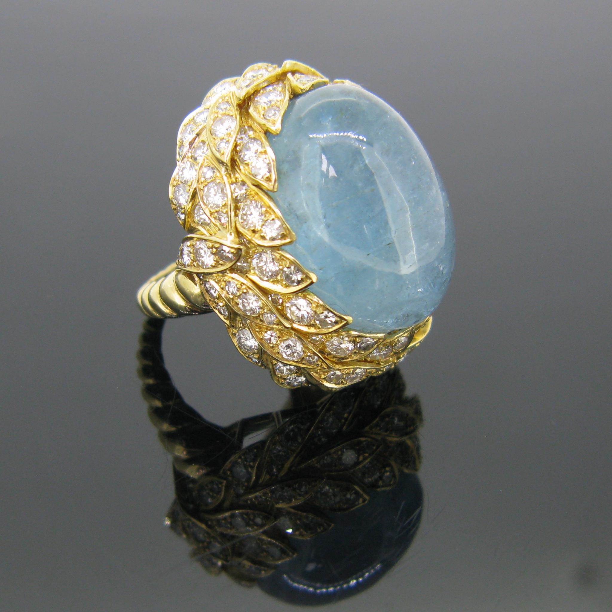 This bold and impressive ring features an incredible 40 carat cabochon cut aquamarine. The aquamarine is set within a nest of 42 leaves motifs with diamonds. There are 141 diamonds set all around the aquamarine on the leaves. The band is made in