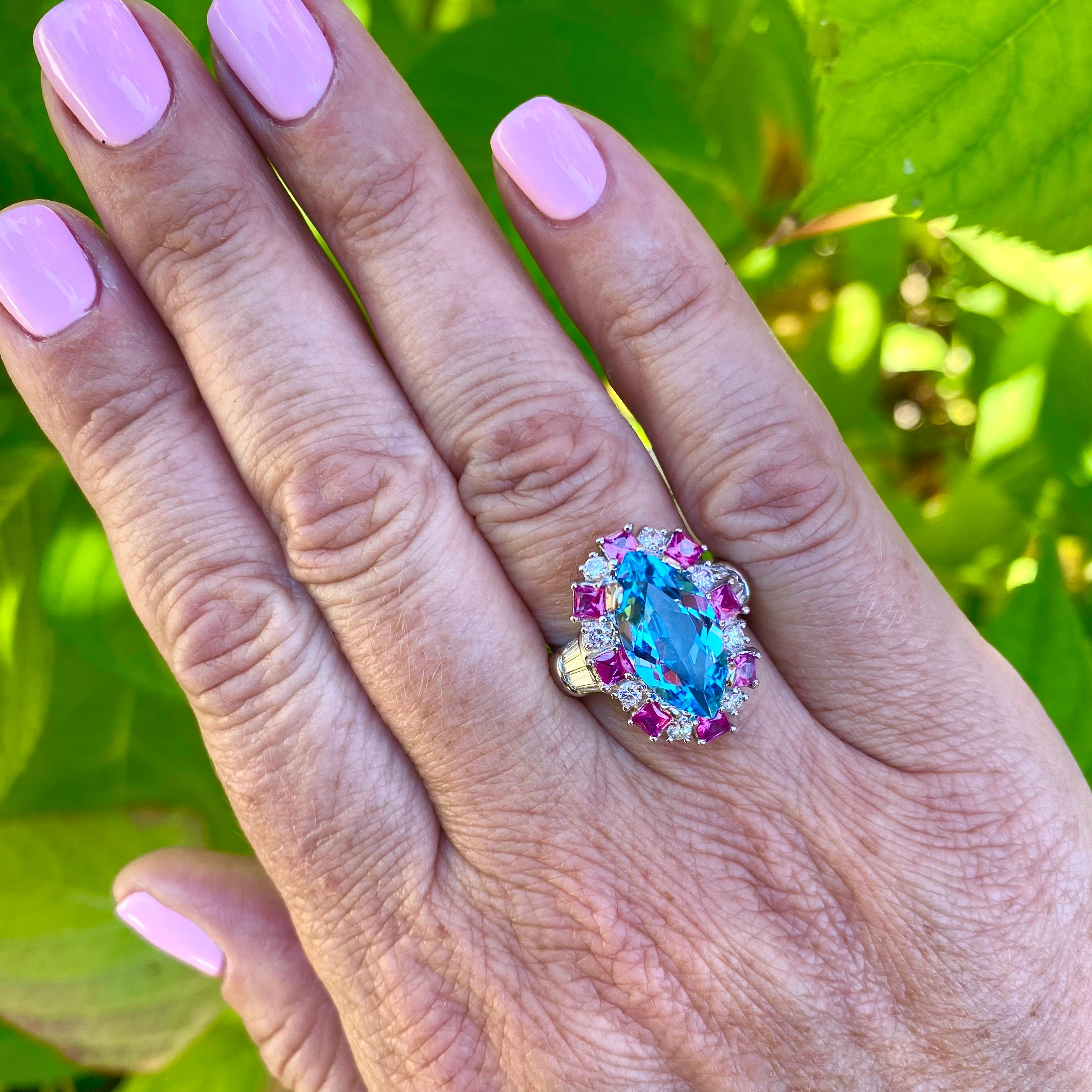A statement ring with a perfect splash of color! Platinum ring features a 4.0 carat Marquise Brilliant Cut Aquamarine accented with 8 square cut Rubies totaling 1.44 carats, and 20 round brilliant & tapered baguette Diamonds totaling 0.88 carats.