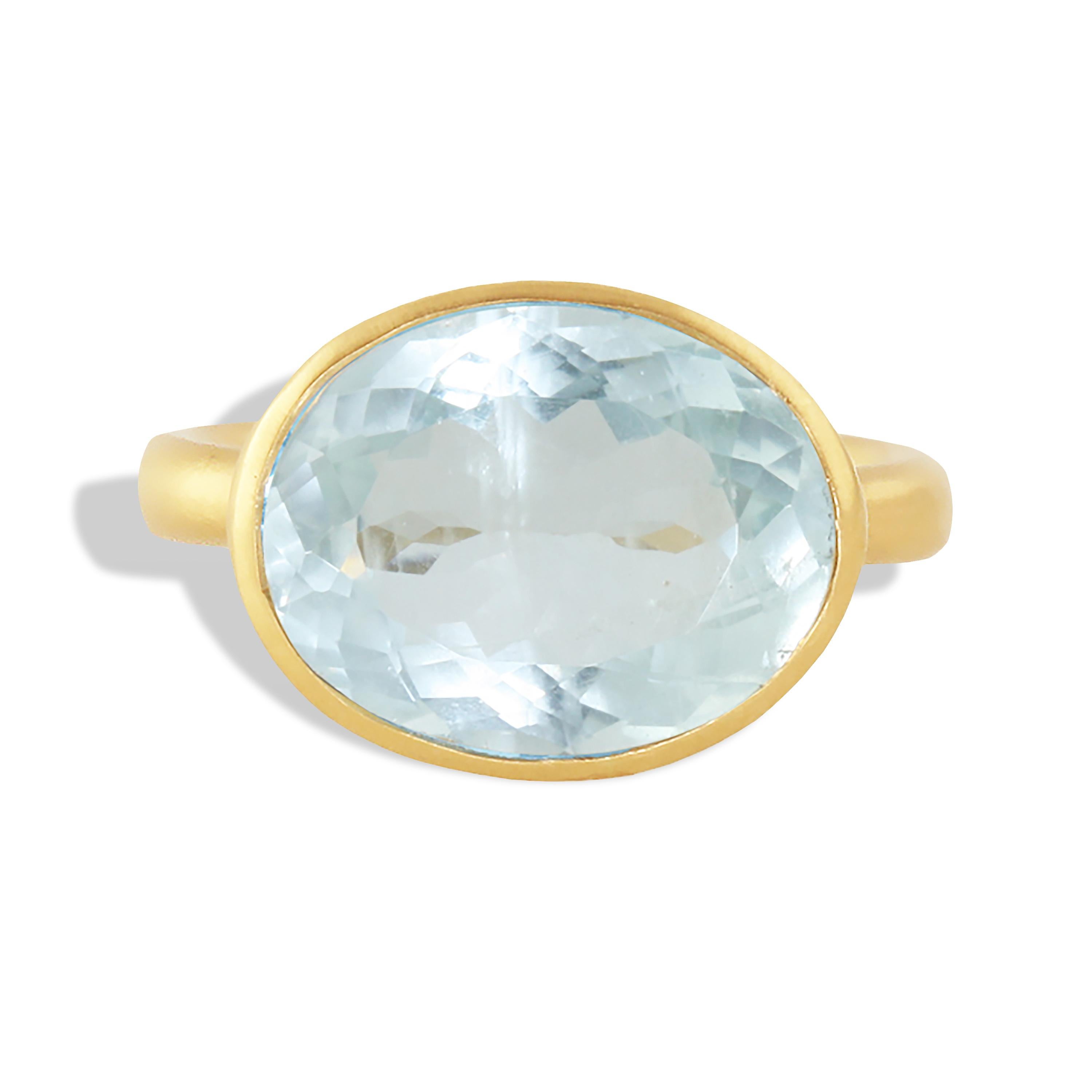 A 7.89 carat light blue shimmering aquamarine ring set in 18k yellow gold with .08 carats of diamonds decorating the wavy bezel it is set in. The name Aquamarine comes from the Latin phrase 