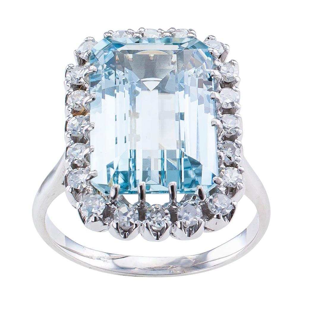 Aquamarine diamond and white gold cocktail ring circa 1950. Showcasing an emerald-cut aquamarine weighing approximately 5.50 carat within a conforming border set with twenty single-cut diamonds totaling approximately 0.50 carat, approximately H