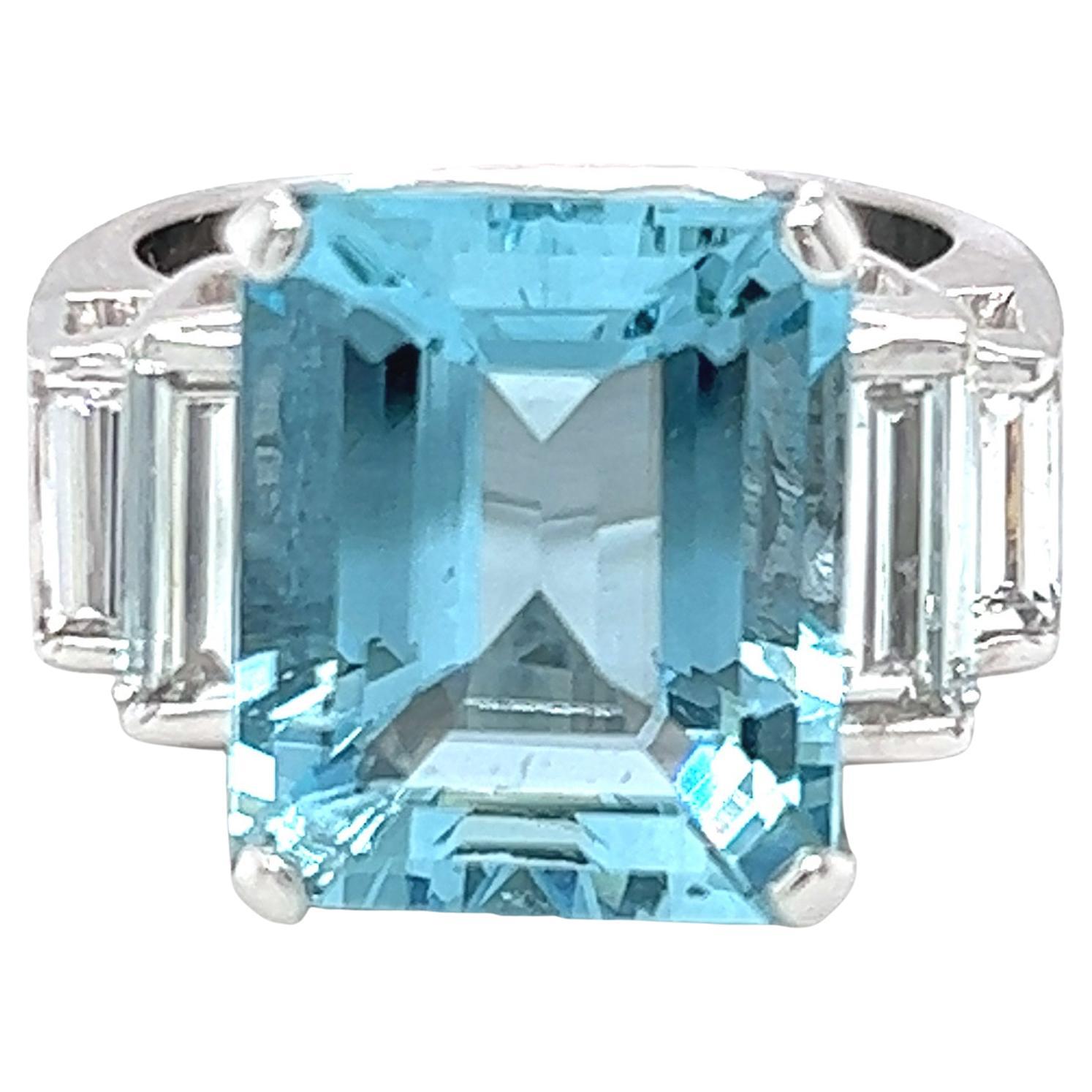 14 karat white gold ring featuring an emerald cut aquamarine with exceptional clarity and hue, complemented by baguette cut diamonds that are F-G color, VS clarity. The aquamarine weighs approximately 8.50 carats and baguettes are 0.50 carats total.