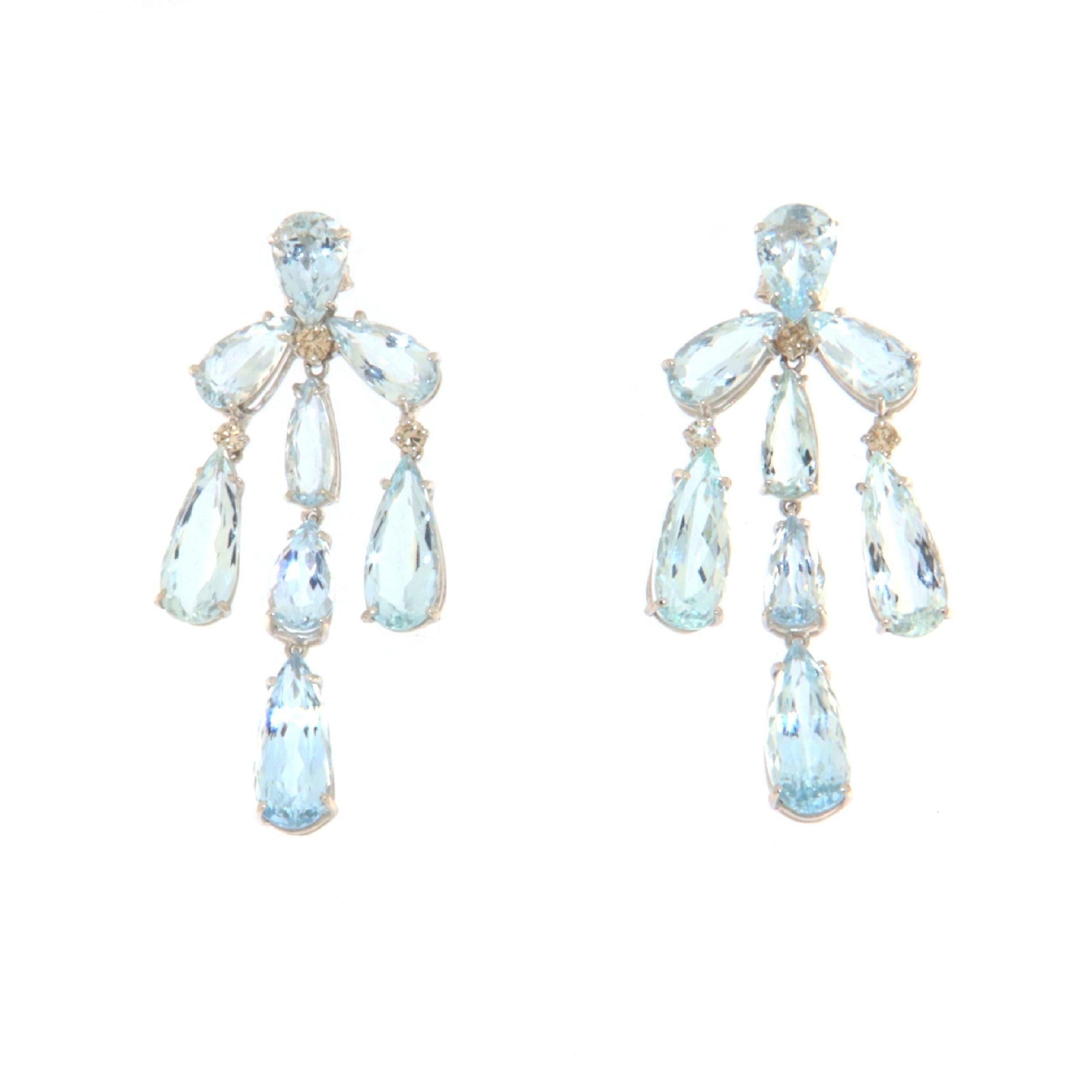 These stunning earrings, crafted from 18-karat white gold, showcase a breathtaking design that marries the serene beauty of Brazilian aquamarines with the dazzling sparkle of brilliant diamonds. Each earring features elegantly cut teardrop