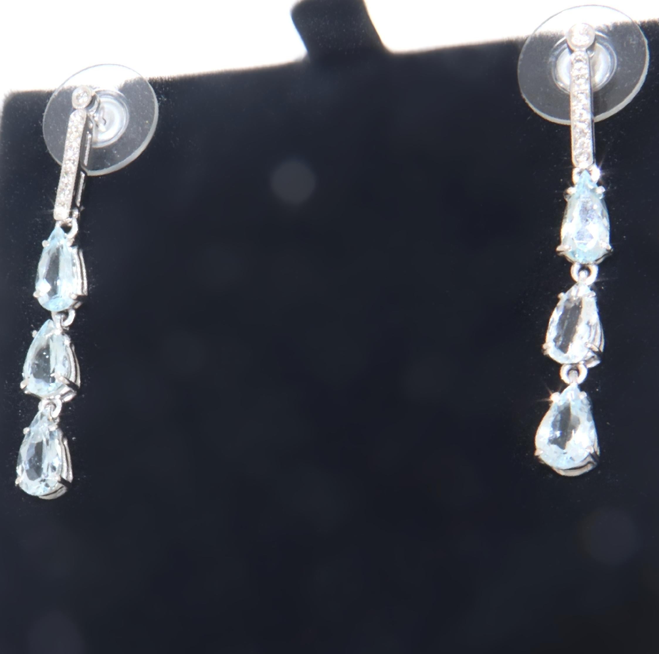 Delicate pendant earrings made in the late nineties by expert goldsmiths from southern Italy, composed of drops of aquamarines (Brazilian origin) supported by a bar where the diamonds are set, mounted in 18-karat white gold, the closure is the cap