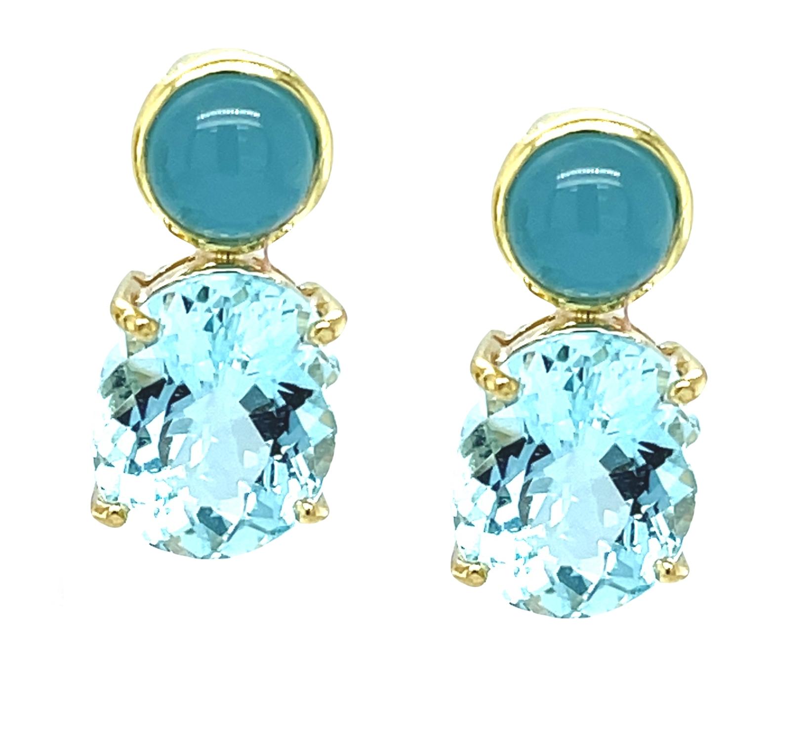 These beautiful earrings feature over 8 carats of lovely blue aquamarines in both sparkling ovals and gorgeous cabochons! The faceted ovals are showcased in handcrafted yellow gold baskets, while the round cabochons are set in bezels for a