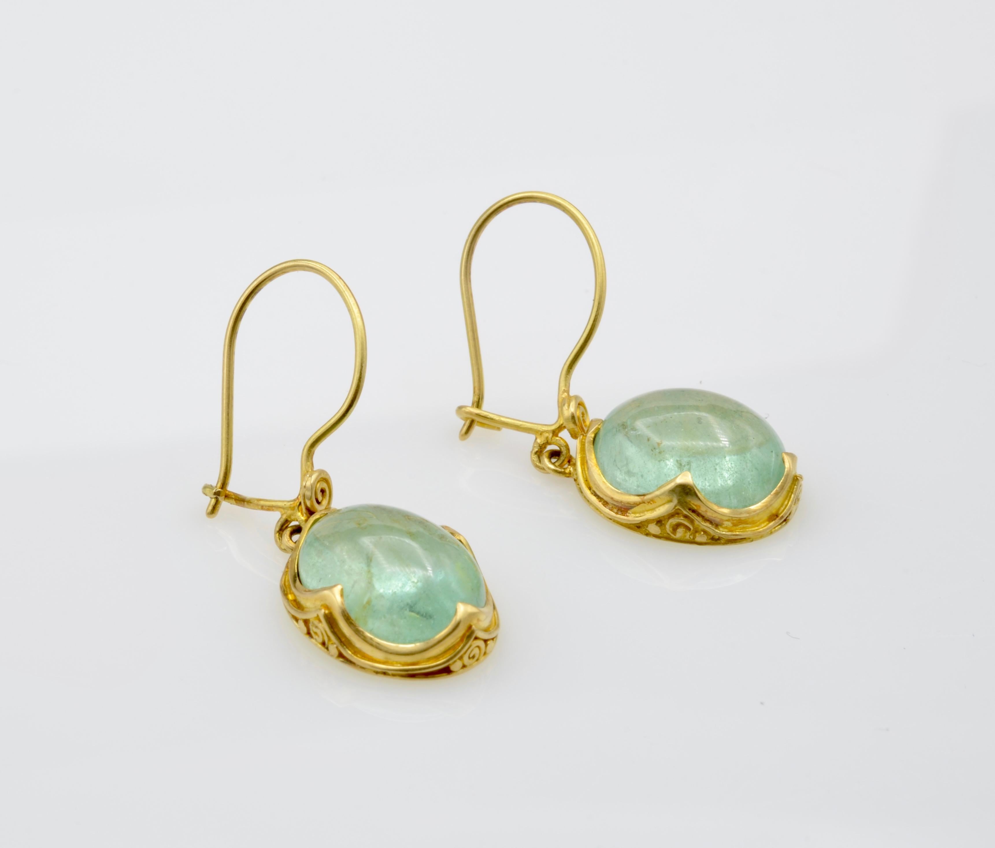 These lovely aquamarine earrings are a turquoise watery blue that dance with refracted light. The 22k bezel beautifully frame these aprox. 3ct each aquamarines with a swirl design ear wire. These are great everyday and/or special occasion earrings.