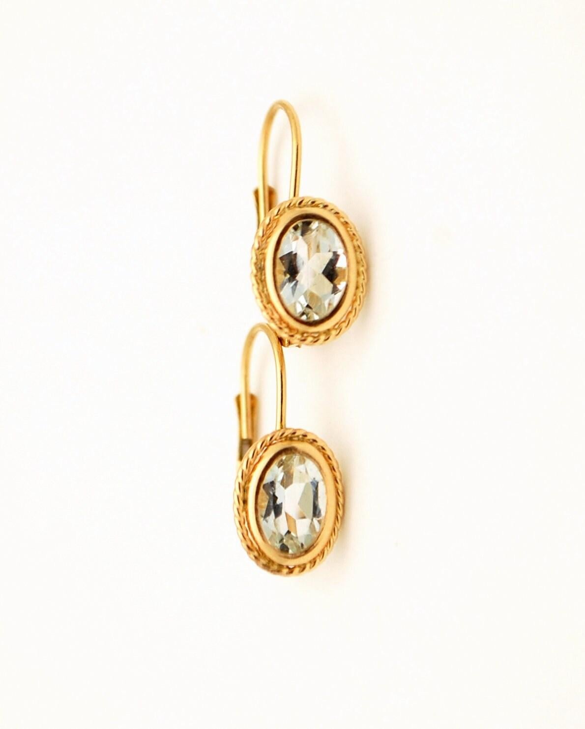 Very prertty lever back earrings with natural aquamarines, elegant design and comfortable closure make these perfect to wear everyday!

Metal: 14KT yellow gold
Center Stone: Natural aquamarine
Color: Very Light Blue
Approximate Weight: