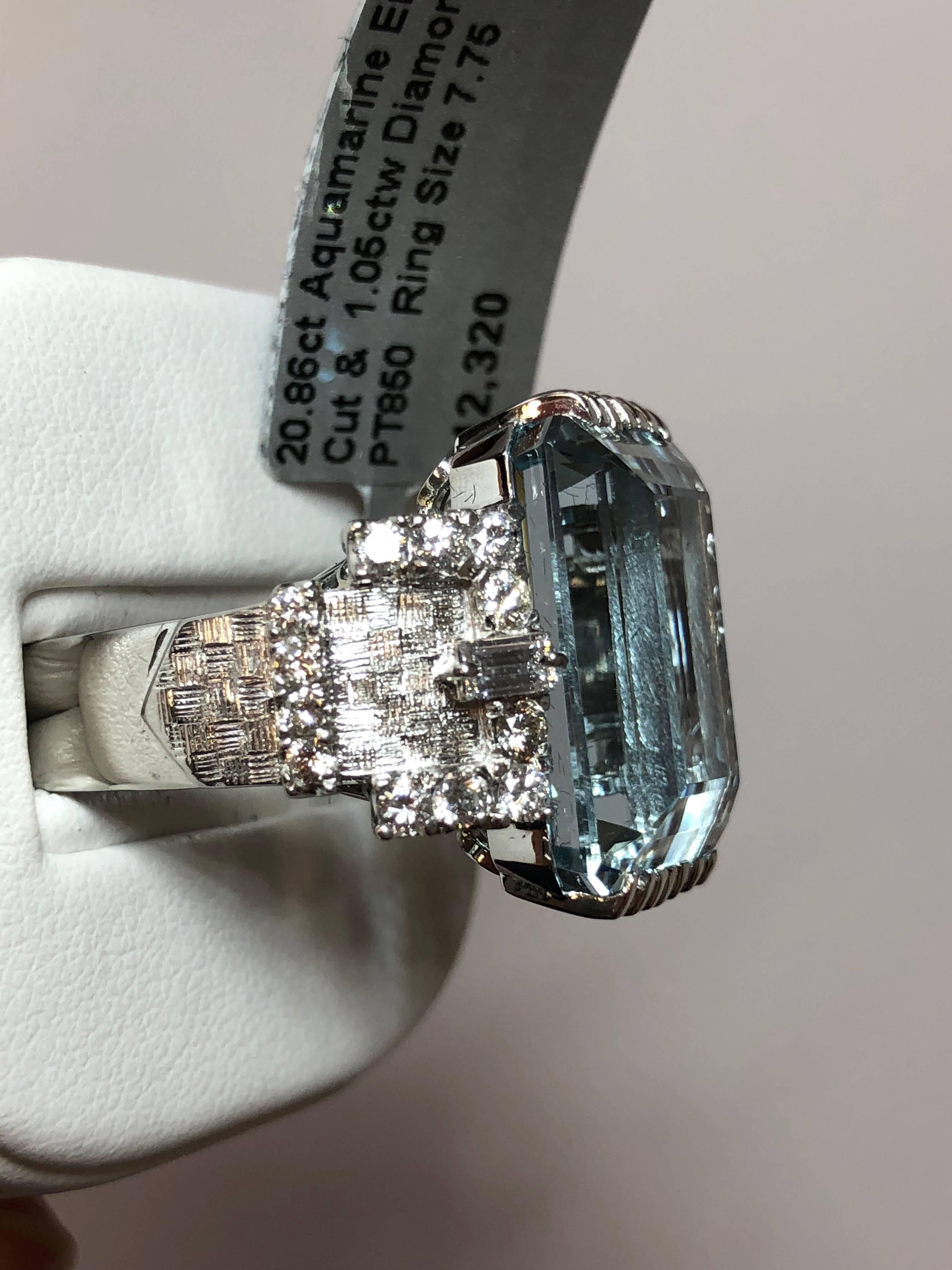 Lovely 20.86 carat aquamarine emerald cut surrounded by 1.05 carats of white diamonds in a platinum mounting.  This cocktail ring is a showstopper and perfect for any occasion! Size 7.75.