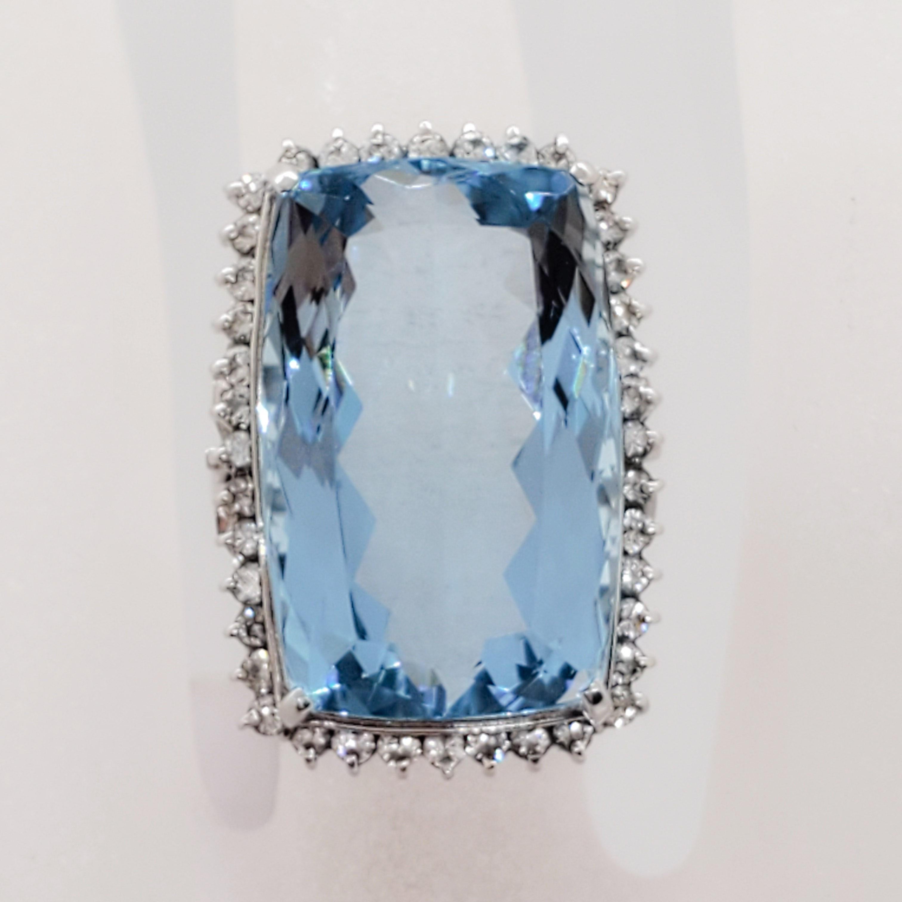 Gorgeous 24.50 ct. aquamarine emerald cut with good color and shape.  0.86 ct. good quality white diamond rounds.  Handmade platinum mounting in ring size 5.5.  Estate ring in mint condition.