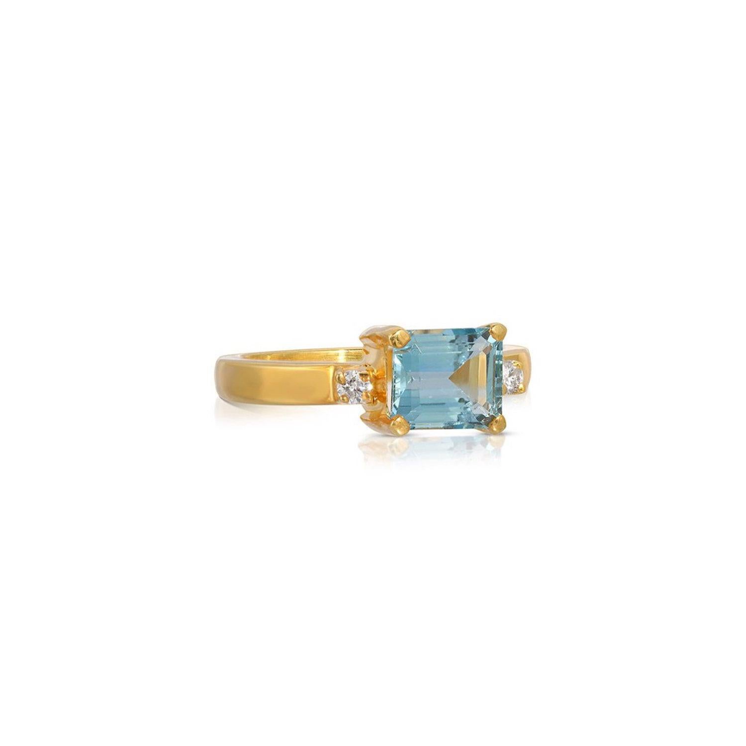 A perfect ring of contemporary design with a beautiful duo of gemstones. This ring features a 2.52 Carats emerald cut Aquamarine centered by .06 Carats of sparkling White Diamonds. This gorgeous ring is set in 22 Karat Gold overlay Silver.