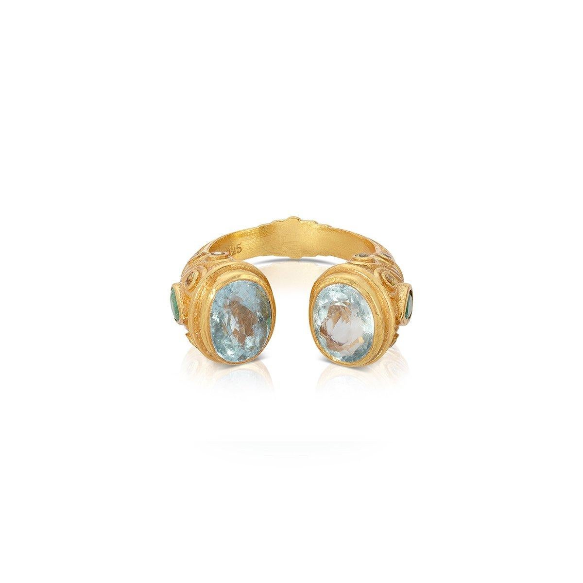 A contemporary interpretation of the opulent jewelry style of the Moguls... An Aquamarine ring featuring an open ended band tipped with fiery Aquamarines and pear shaped Emeralds on the side of the ring. 

- Natural Aquamarines weight approx 4.9