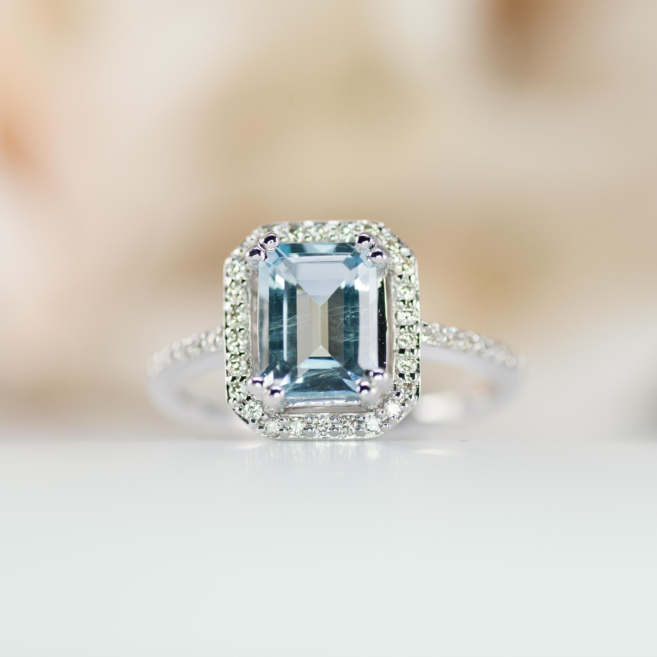 An emerald cut natural aquamarine adds color to this vintage style engagement ring.

The aquamarine is a little over 1.50ct and is a large gemstone with a beautiful light blue color.

You will receive the ring in the pictures.

Standard ring sizes