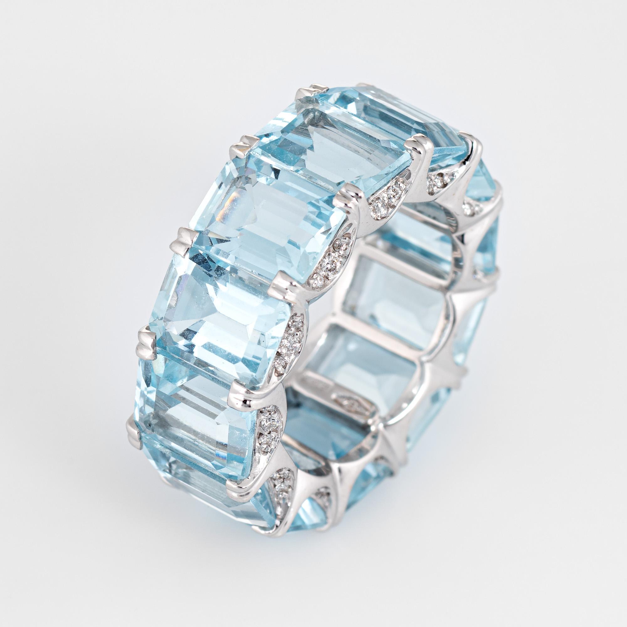 Stylish aquamarine & diamond eternity ring crafted in 18 karat white gold. 

12 emerald cut aquamarines are each estimated at 1.50 carats with a total estimated weight of 18 carats. The aquamarines are in excellent condition and free of cracks or