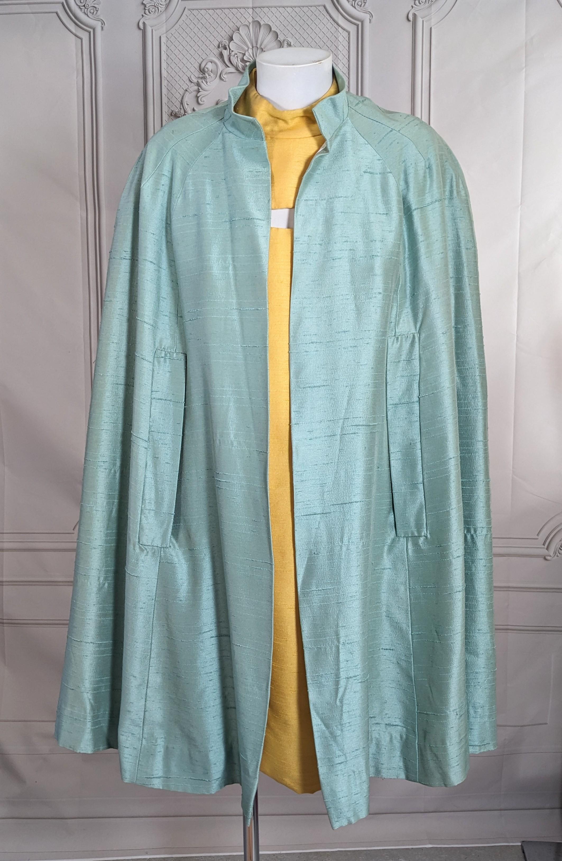 Charming Aquamarine Flared Raw Silk Cape from the 1960's. Cut with Mandarin collar and slash openings for hands. Fully lined. No closures. 1960's USA.