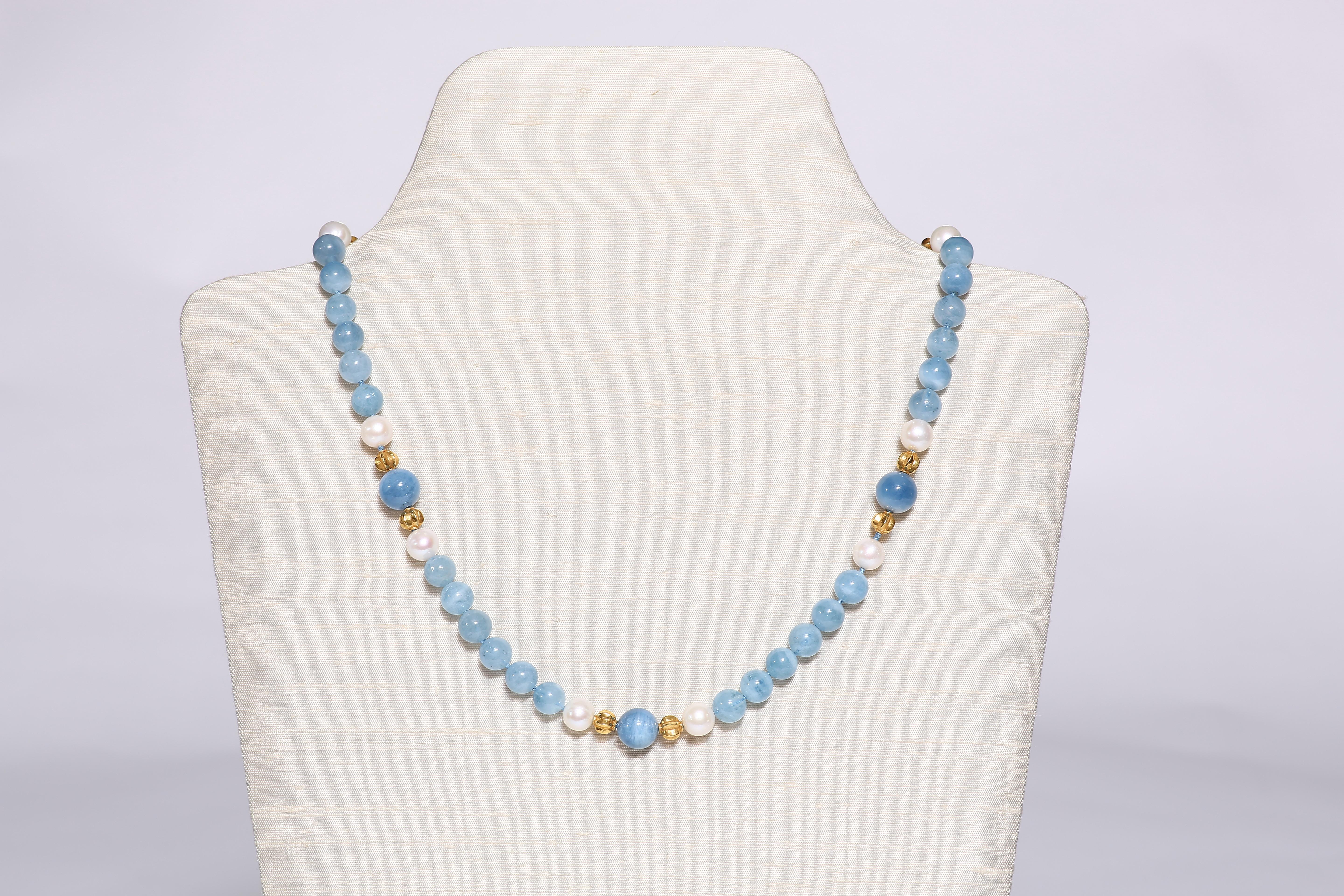 Round calming blue aquamarine beads; in two sizes, are accentuated by 18k gold beads and fresh water pearls.  A charming classic necklace of 21 1/2