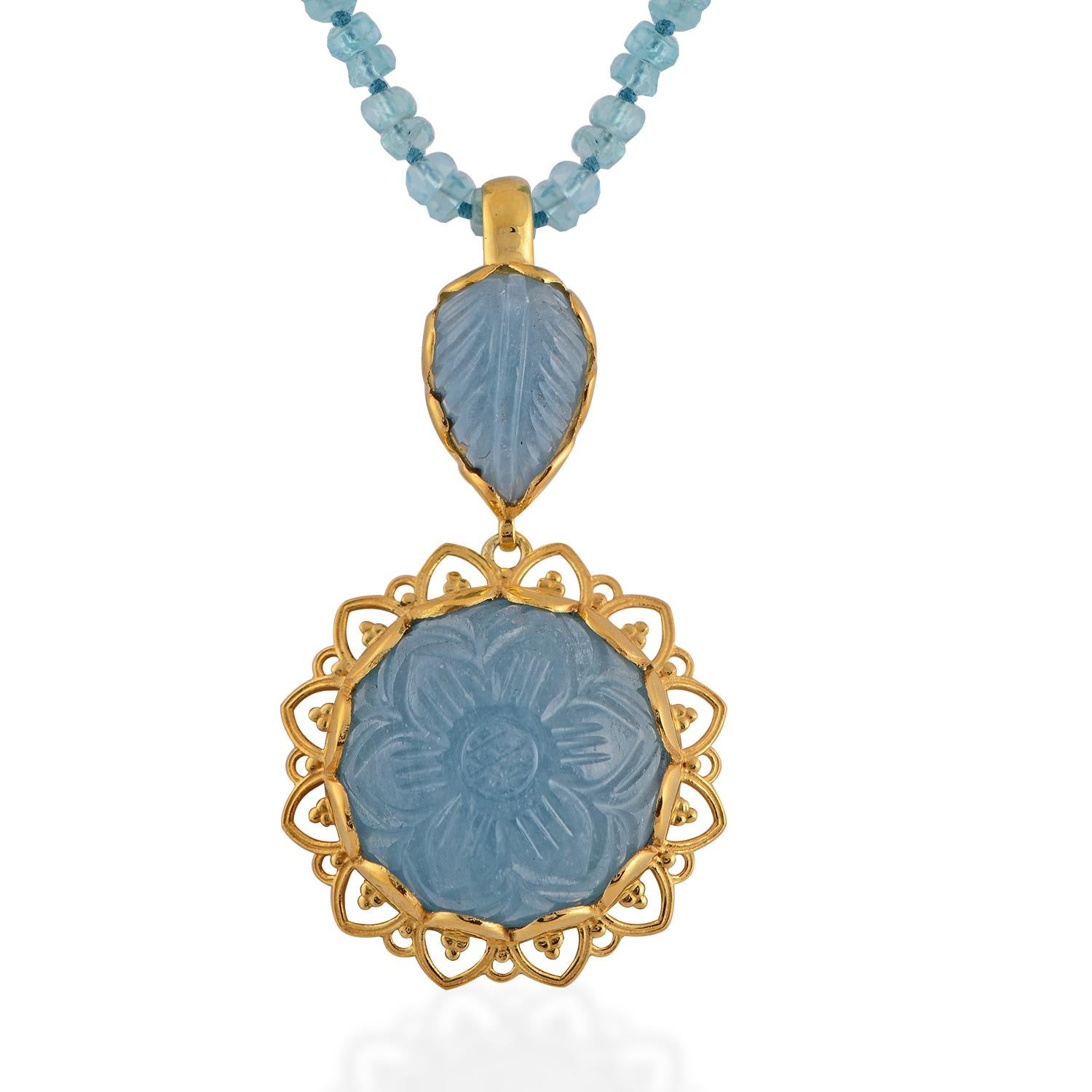 

This beautiful one of a kind pendant has been handmade in our workshops. We have used jaali and embossed work in this pendant and embedded it with hand carved aquamarines. The pendant is made in sterling silver with 24ct gold vermeil and comes