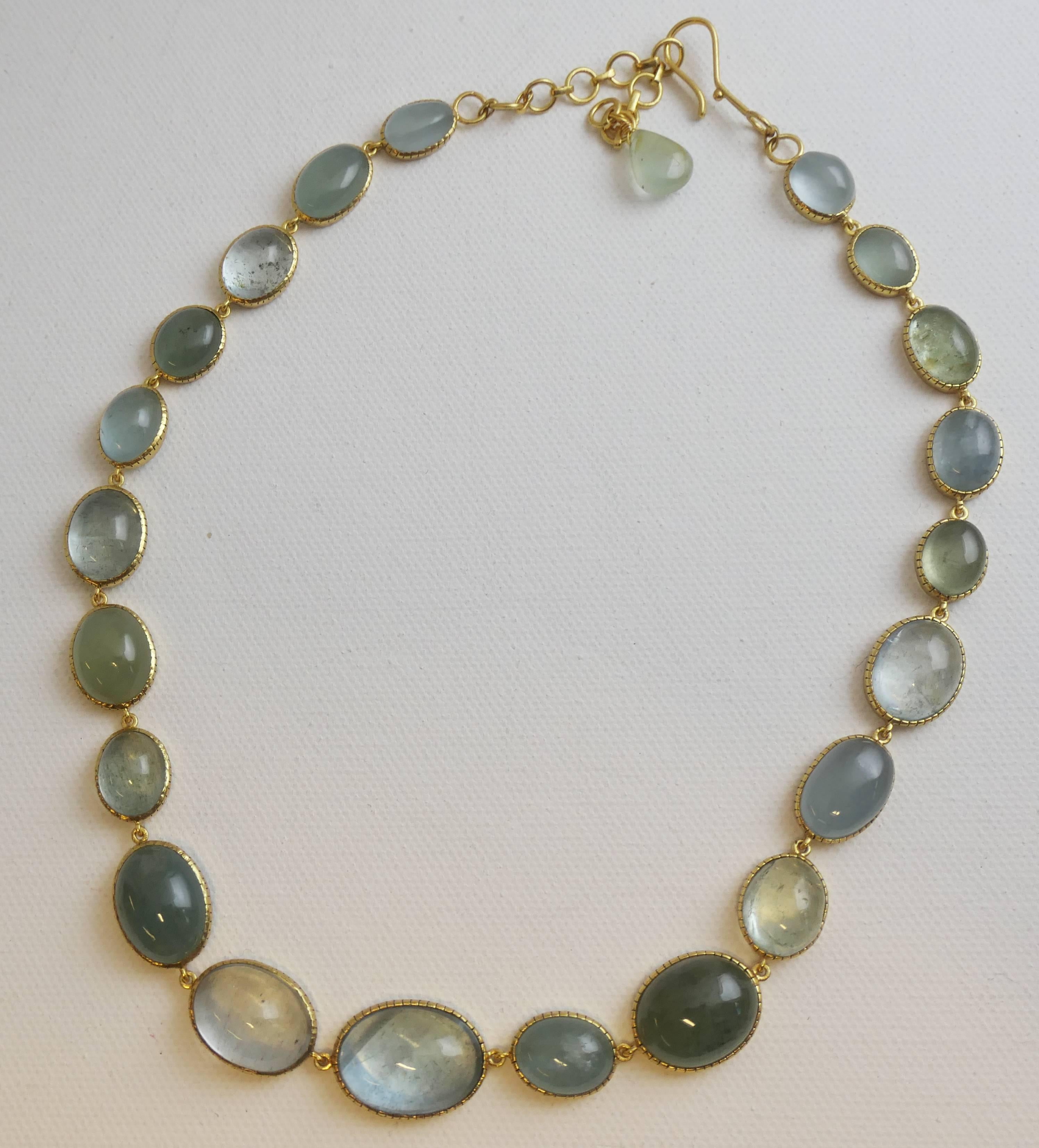 This single strand aquamarine necklace is 17 inches long with an additional 3 inch of extension chain and it has a hook clasp. The cabochon aquamarine are of varying shapes and sizes, ranging from 10 to 20 mm in diameter.