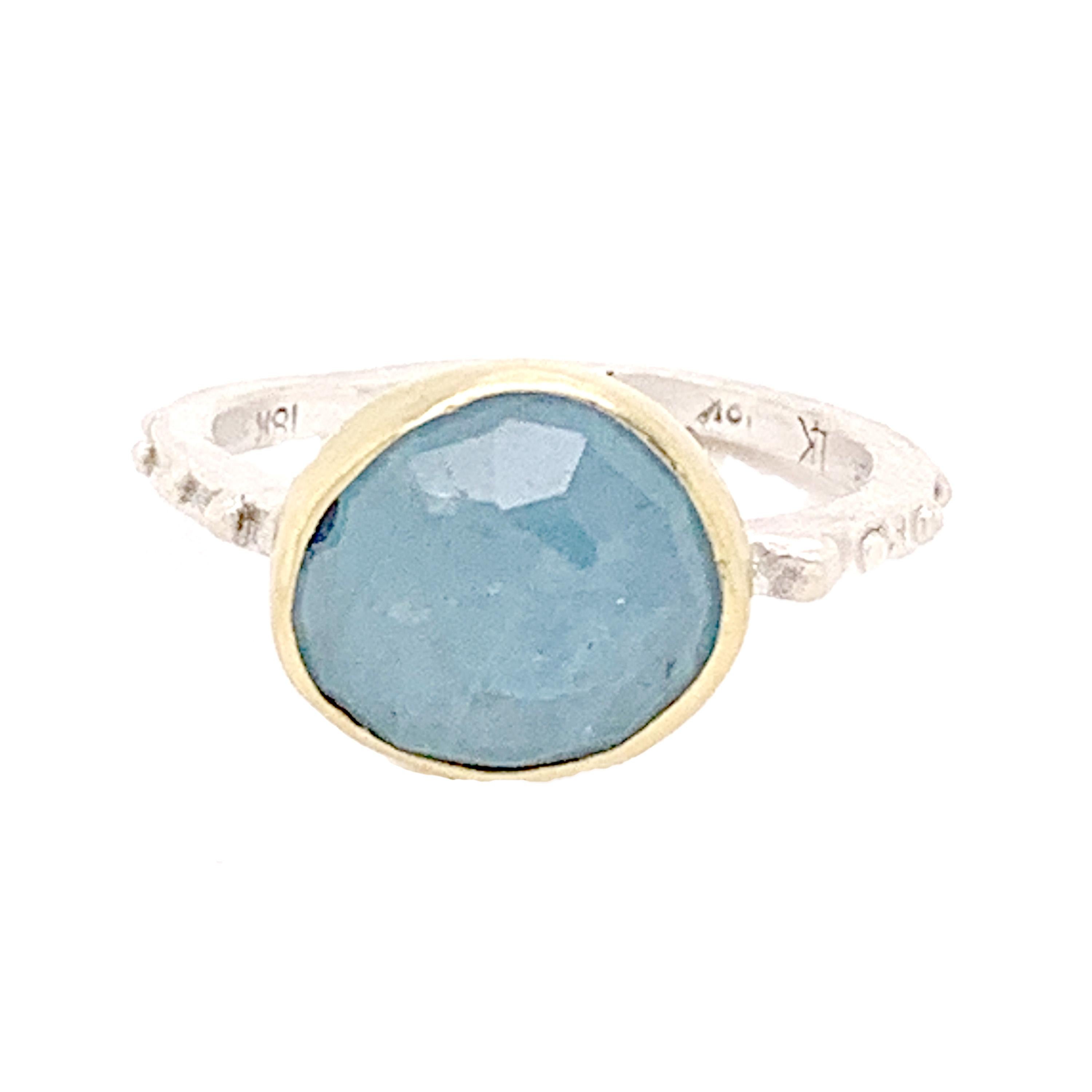 Simple rose-cut aquamarine, nestled into an 18k Gold bezel setting with a sterling back and sterling stackable band.  This piece is hand made and one of a kind.
Size - 6.5