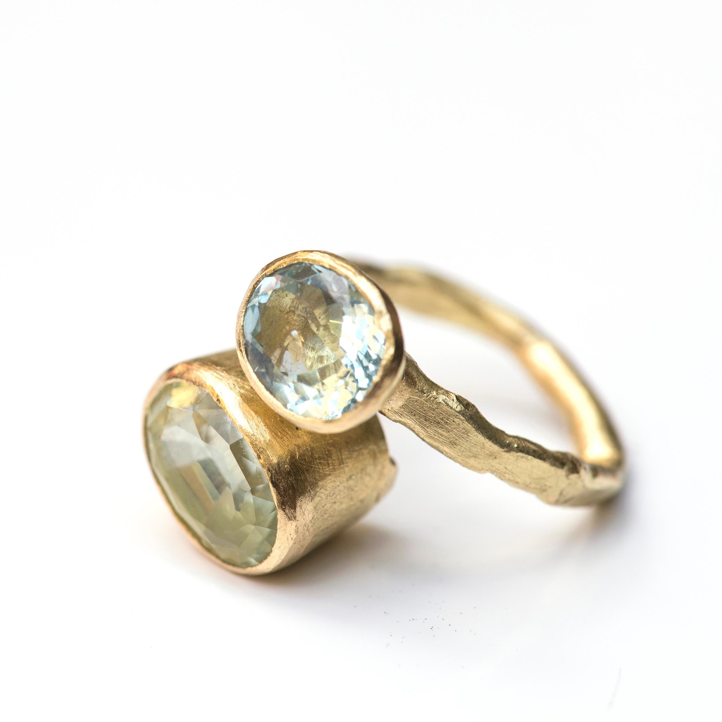 Three carat oval aquamarine and 6 carat green beryl double gemstone ring. Made in 18k yellow gold these stunning pastel coloured gemstones are in rub-over settings to frame each stone. Handmade by Disa Allsopp using her signature textural finishes