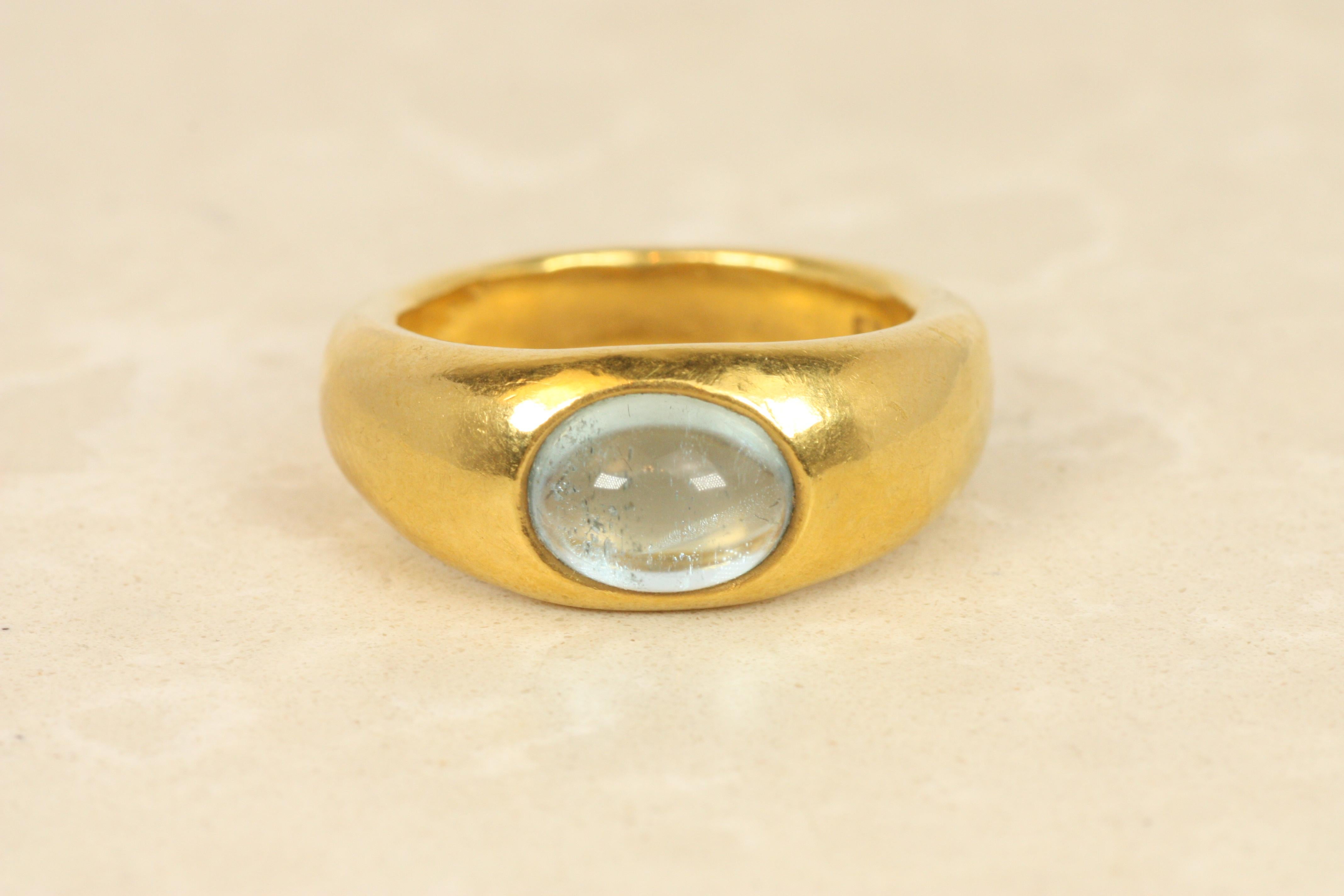 A striking tribute to ancient design, the Darlene deSedle “Caesar Ring” by Todd Bracken is a contemporary heirloom. A luminous aquamarine cabochon, reminiscent of crystalline waters, is set in a bold 22K yellow gold gypsy-style band. Its weight and