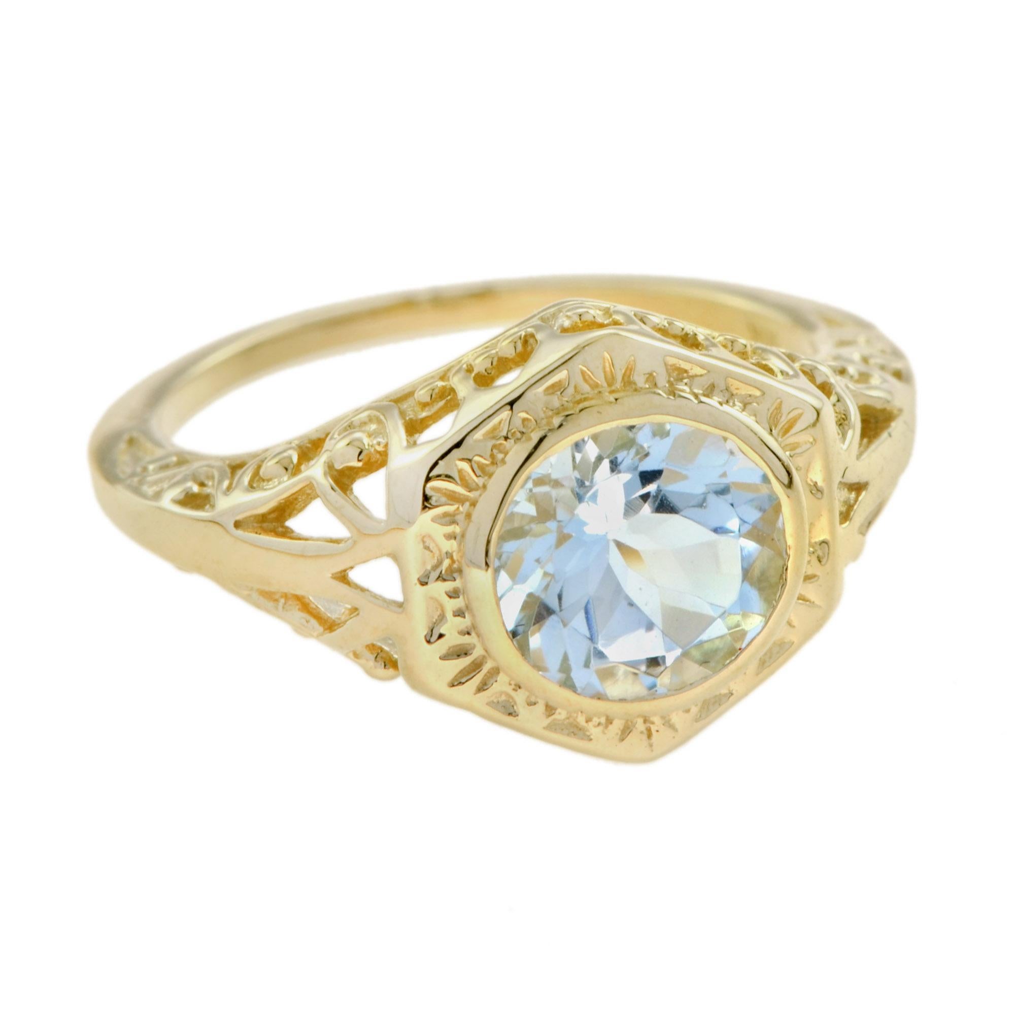 Crafted in 18K yellow gold, this gorgeous vintage style Art Deco filigree aquamarine engagement ring features a shimmery blue natural aquamarine of 0.85 carats, set in a secure bezel-set concentric hexagonal filigree setting. A great choice for