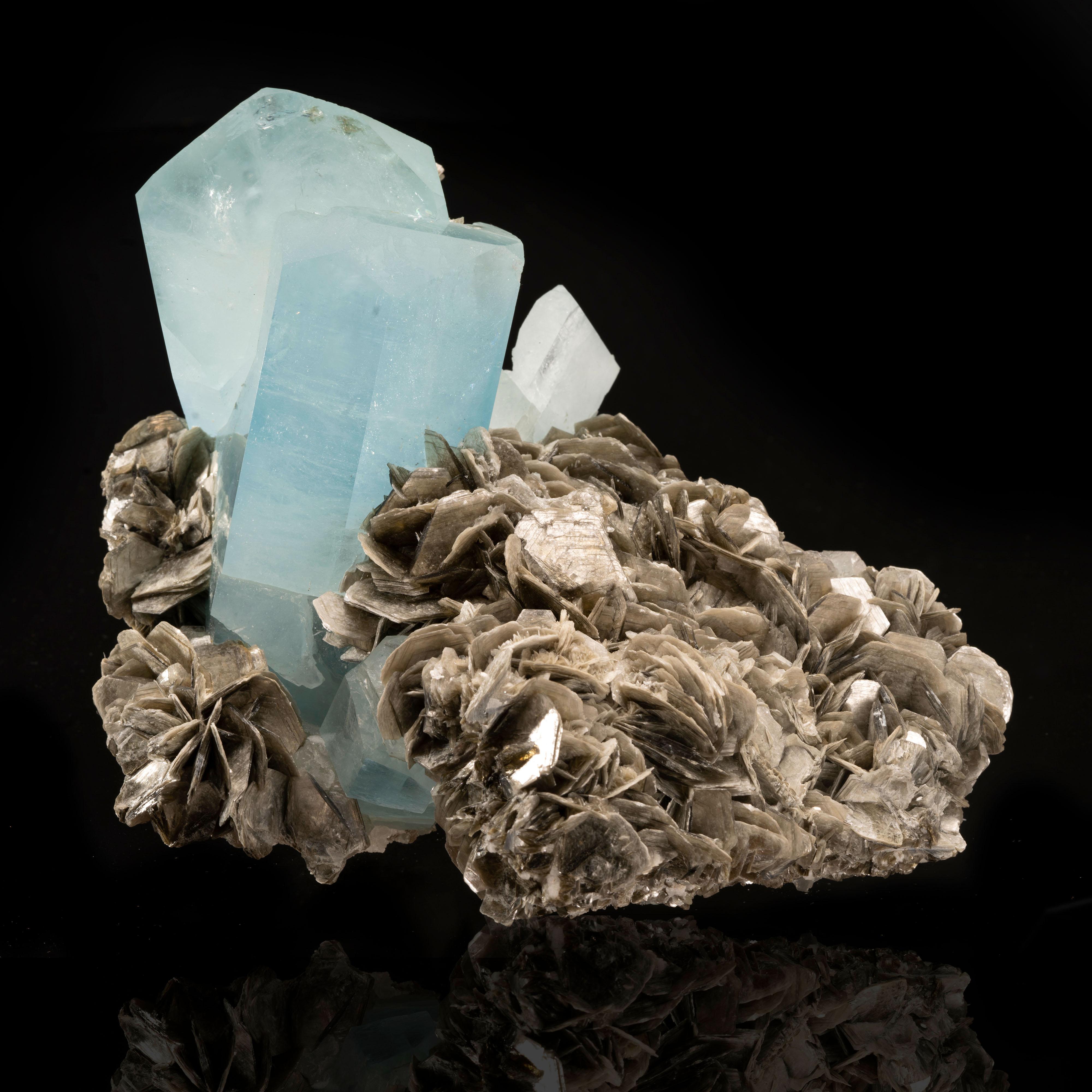 This 6.5 pound cluster of huge, glassy, damage-free aquamarine crystals with lovely color out of Nagar, Pakistan is embedded in a generous mound of lustrous, floral muscovite for a fascinating juxtaposition of textures. The largest two crystals are