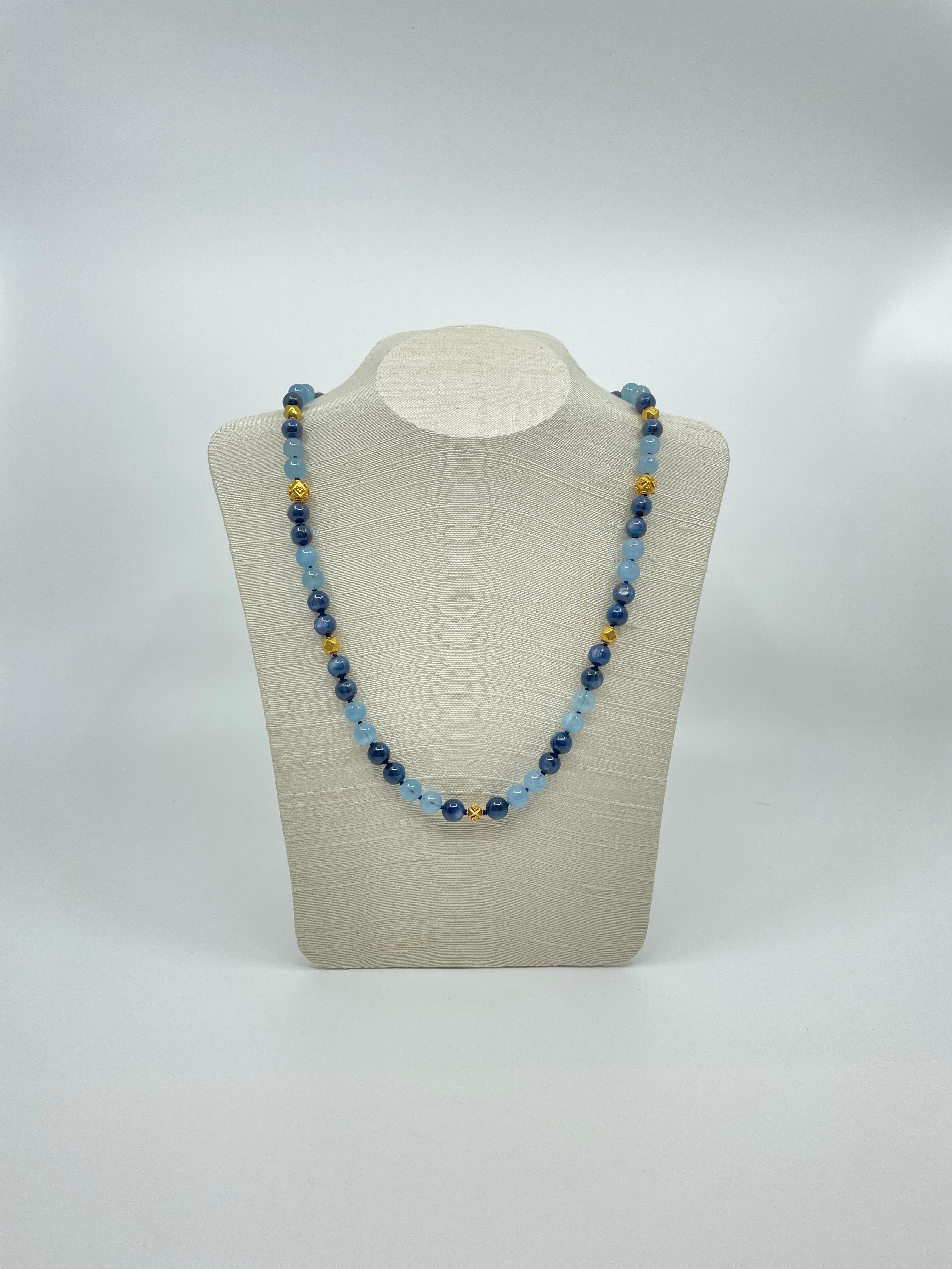 A hand-made necklace of wonderful dark blue kyanite beads, round aquamarine beads, spaced by 18k gold beads and closes with an 18k gold toggle clasp. 
Exquisite for summer days and nights.
Length: 22.5