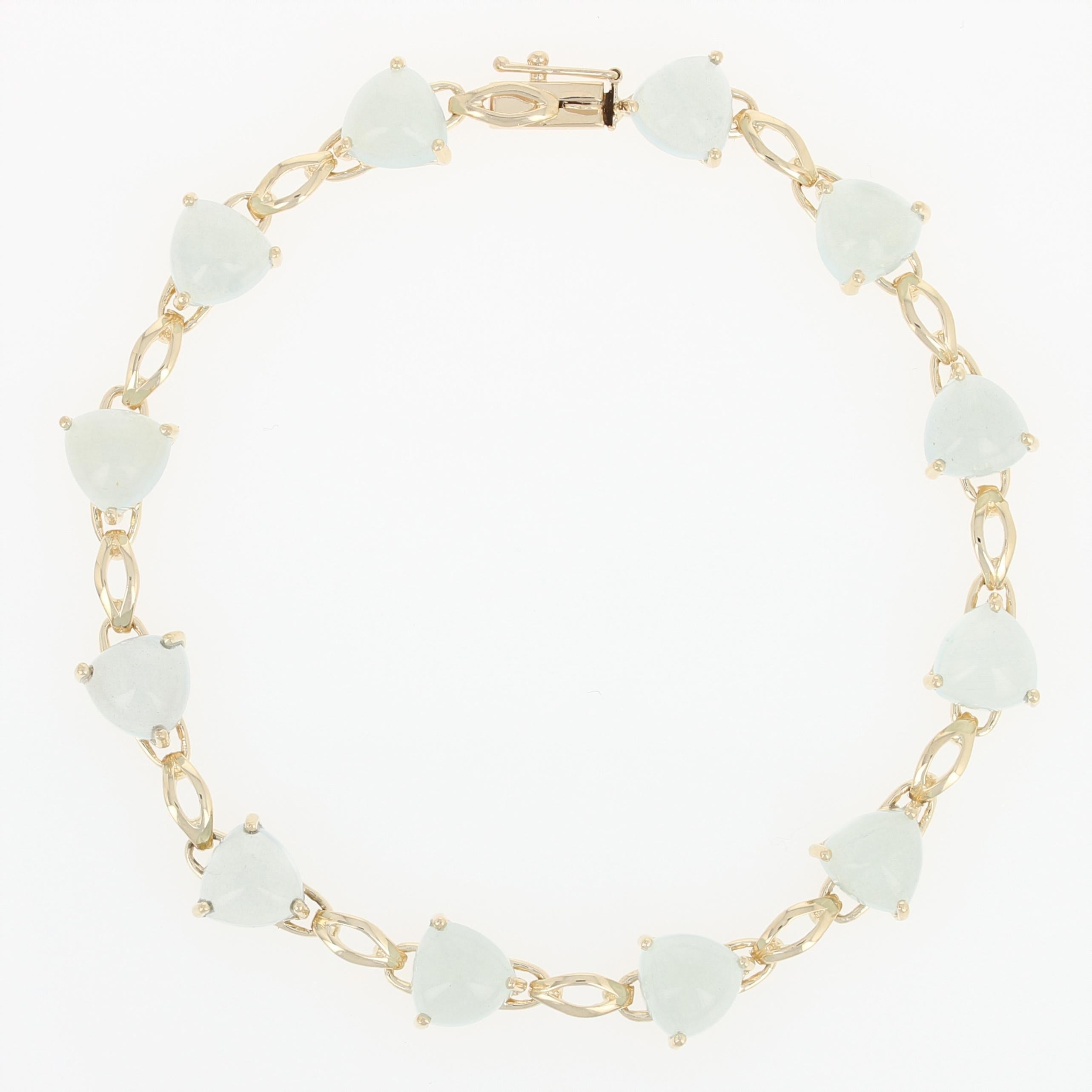 Delight your March birthday girl with this wonderful surprise! Fashioned in an elegant link style, this 14k yellow gold bracelet showcases aquamarine trillion cabochons which are held in open-backed mounts to illuminate each gemstone's sweet blue