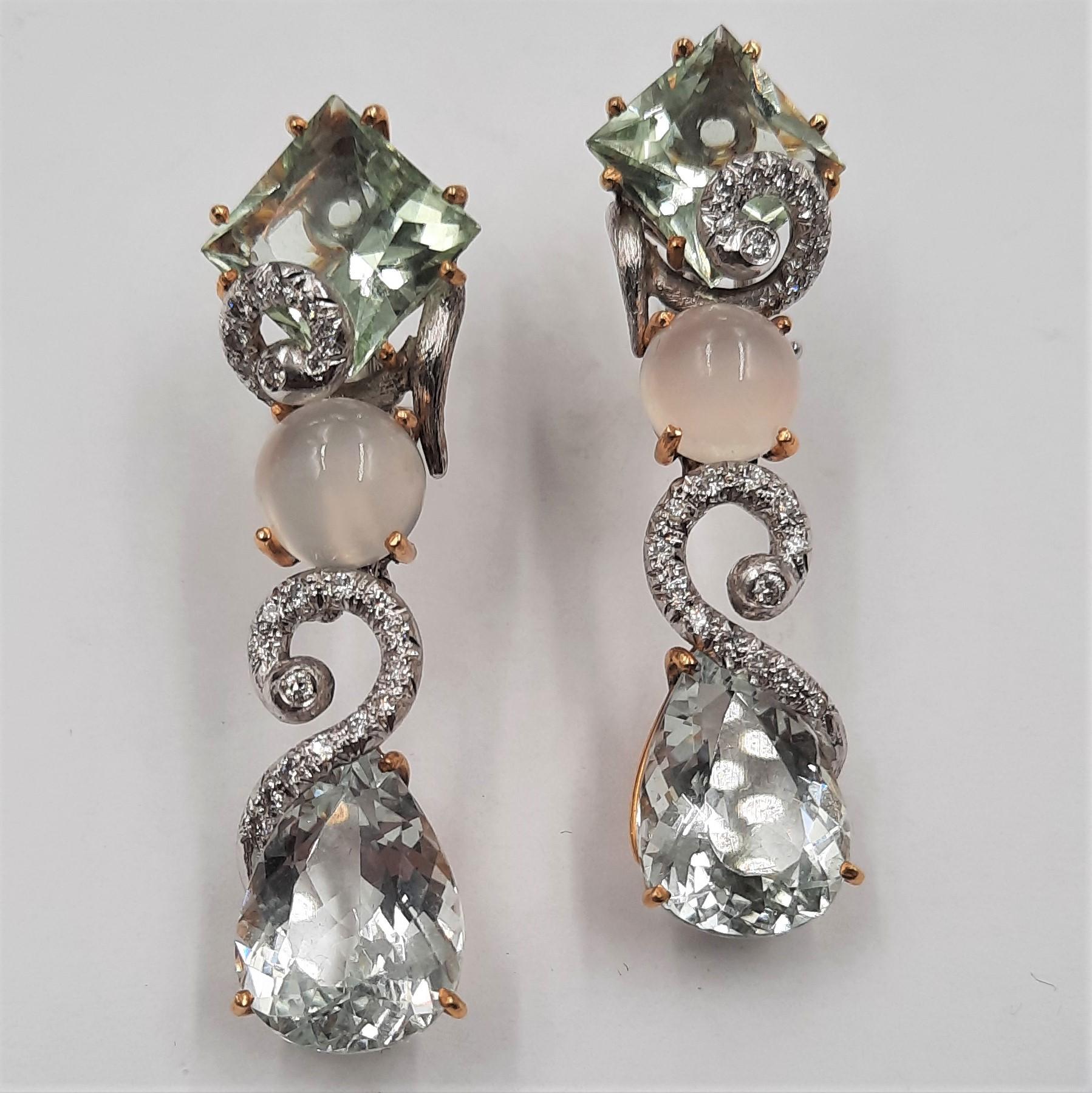 Very elegant aquamarine (24.77 carats), moonstone (1.1 grams), Brilliant cut diamond (0.53 carats), 18 carats yellow and white gold (15.2 grams) dangle earrings. 