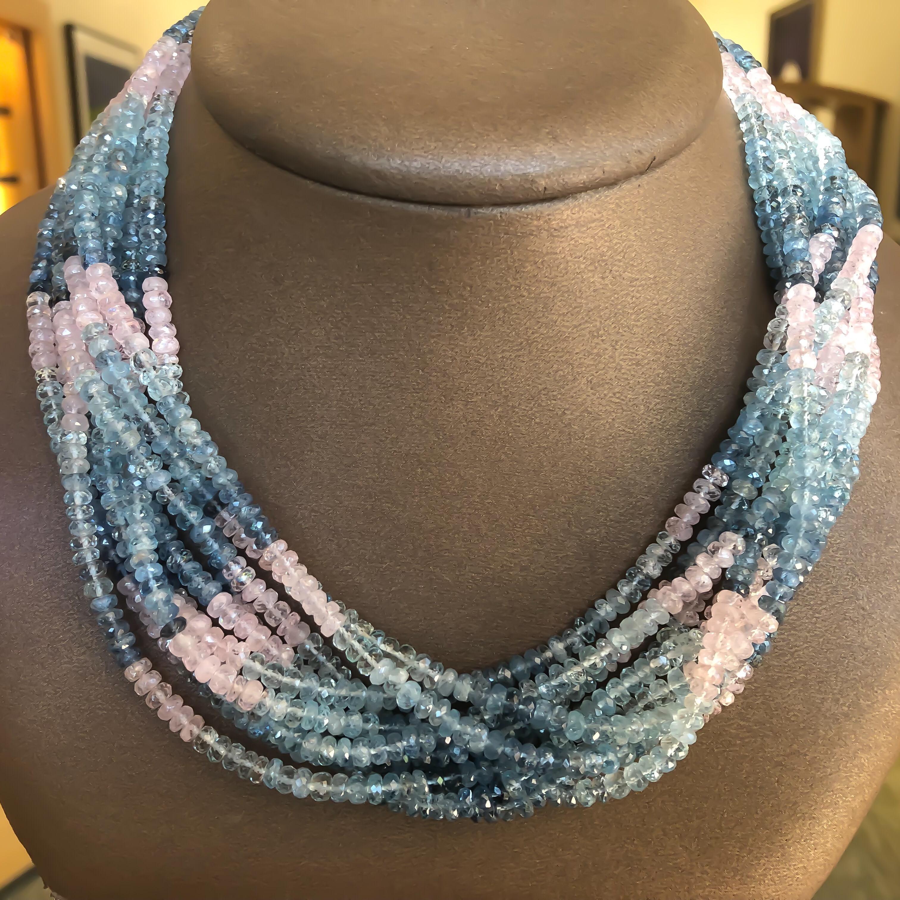 Custom designed natural aquamarine (blue) and morganite (pink) beryl fashion necklace designed with a 18 karat yellow gold clasp. There are ten (10) strands of ombre graduated color beads attached to a toggle clasp. This piece looks lovely on any