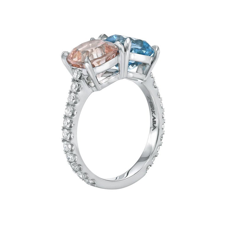 Splendid mismatched pair of Aquamarine and Morganite cushions, weighing a total of 4.02 carats, are decorated with a total of 0.55 carats of round brilliant collection diamonds, mounted in this exclusive platinum ring.
Size 6. Re-sizing is