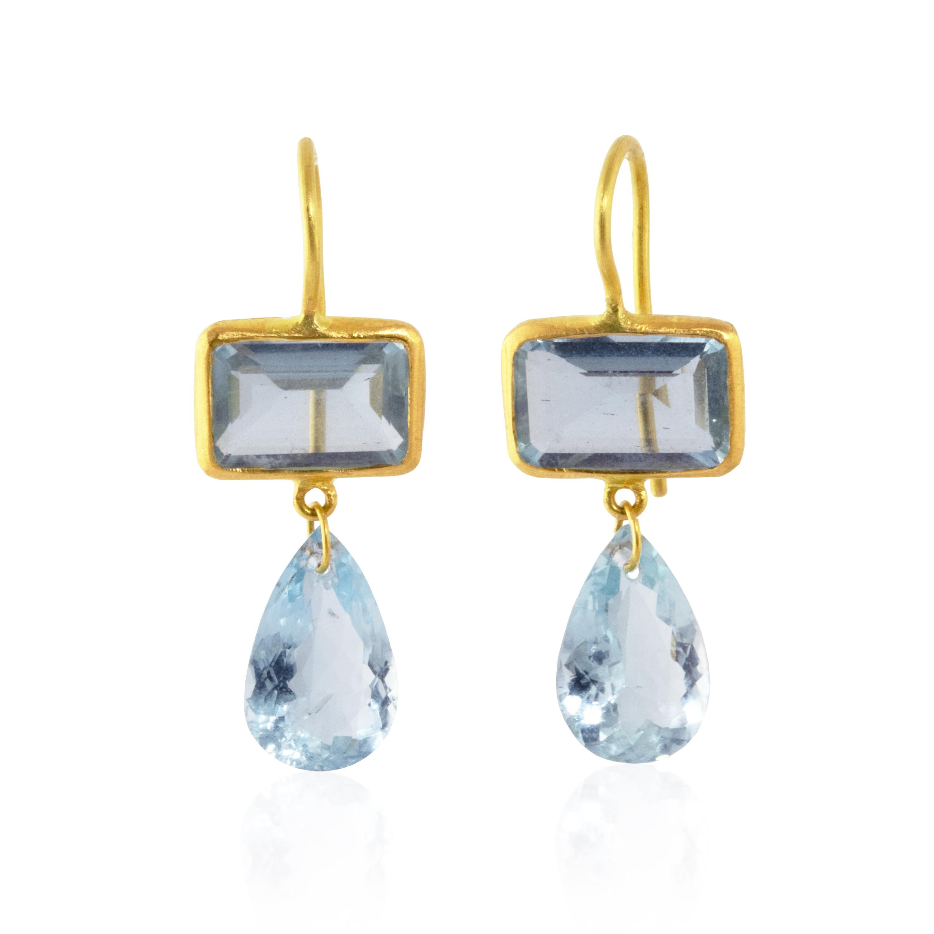 Elegant, essential drop earrings highlight the shimmering beauty of 9.2 carats of aquamarine rectangle and pear gemstones. The top gems are set in 22k gold with matching pear shaped drops. The color is a medium, deep blue color found in Santa Maria