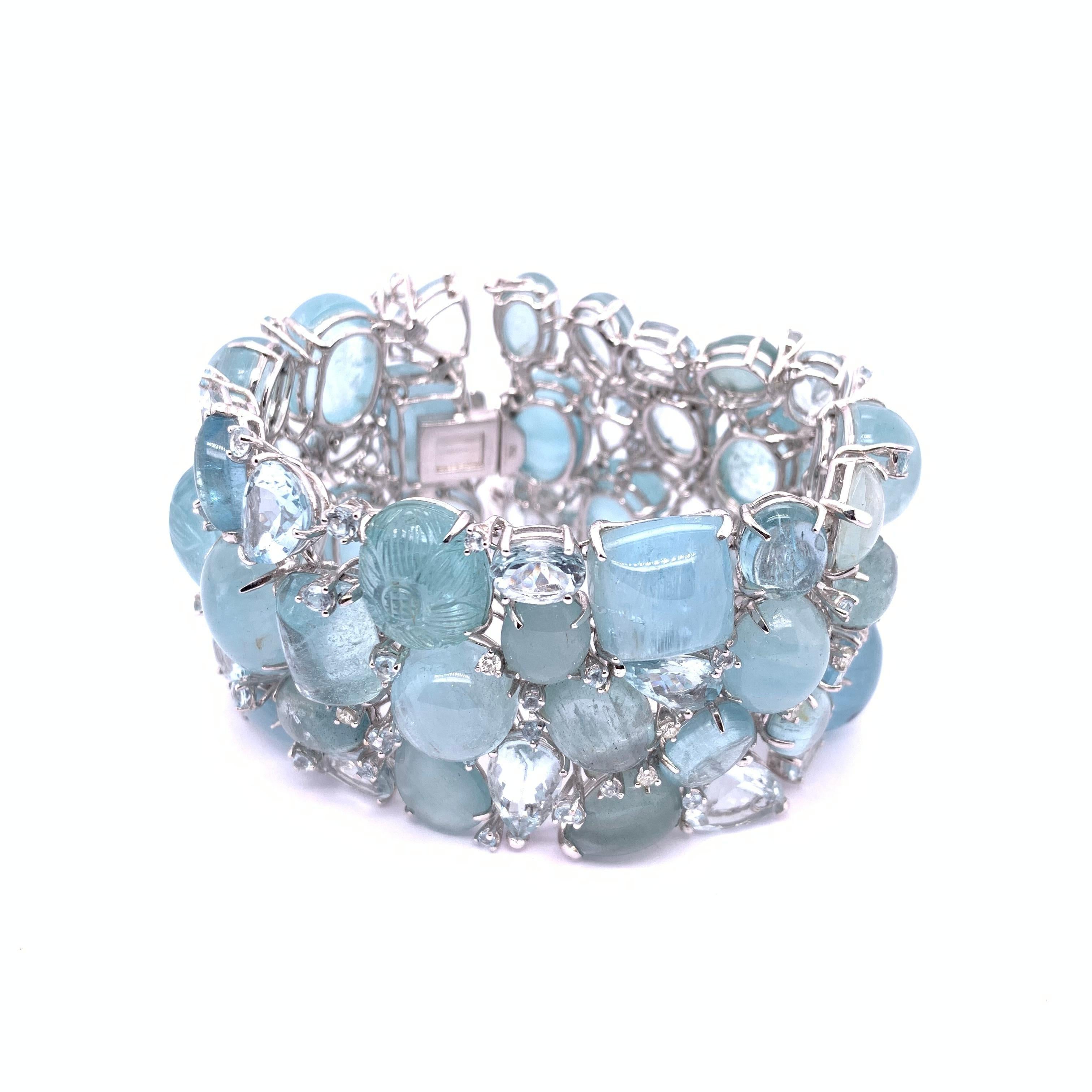 A multi stone aquamarine bracelet, made by Moira, set with mixed cuts of faceted and cabochon aquamarines, weighing an estimated 369.00ct, and round brilliant-cut diamonds weighing an estimated 0.91ct, mounted in 18ct white gold. With a push-in