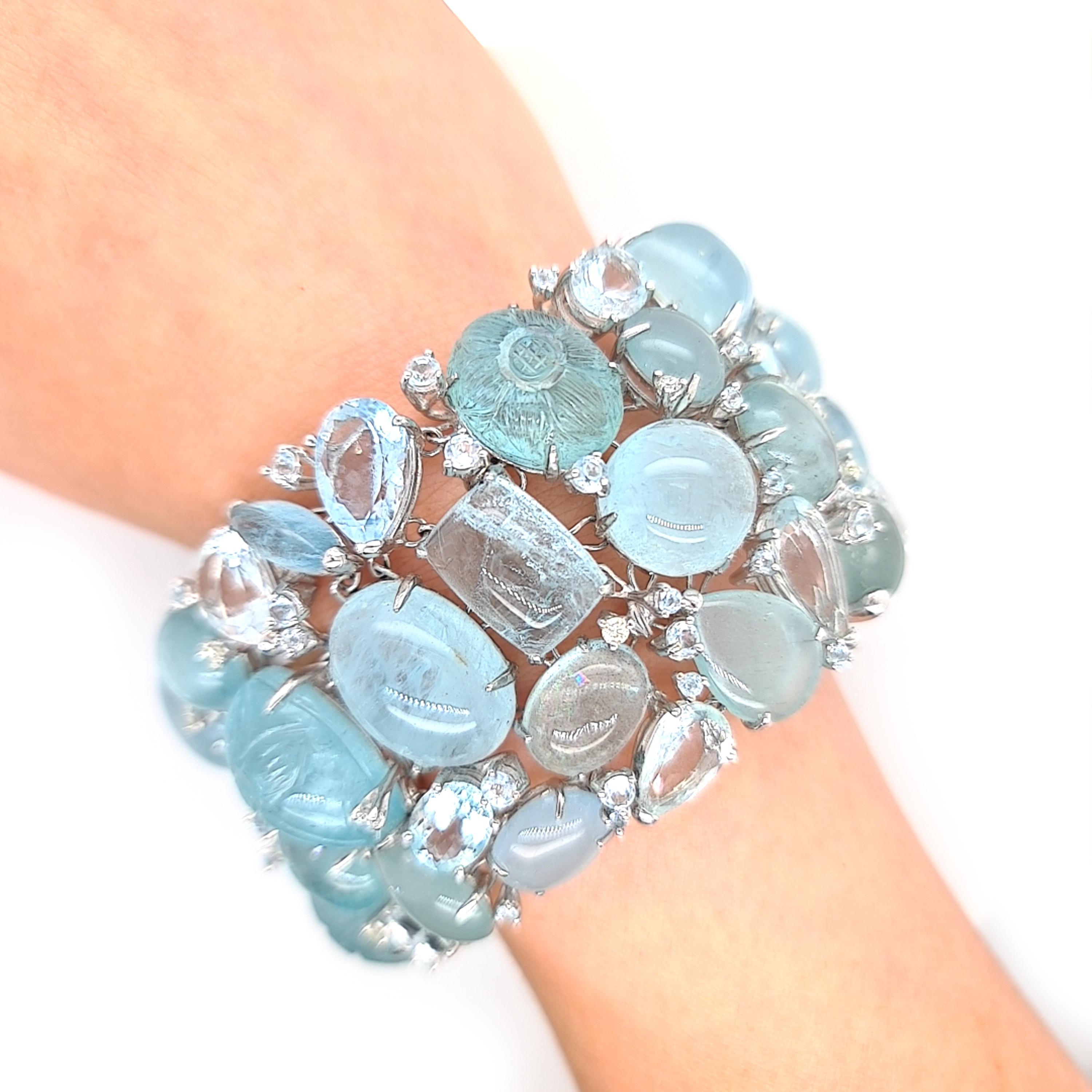 A multi stone aquamarine bracelet, made by Moira, set with mixed cuts of faceted and cabochon aquamarines, weighing an estimated 369.00ct, and round brilliant-cut diamonds weighing an estimated 0.91ct, mounted in 18ct white gold. With a push-in