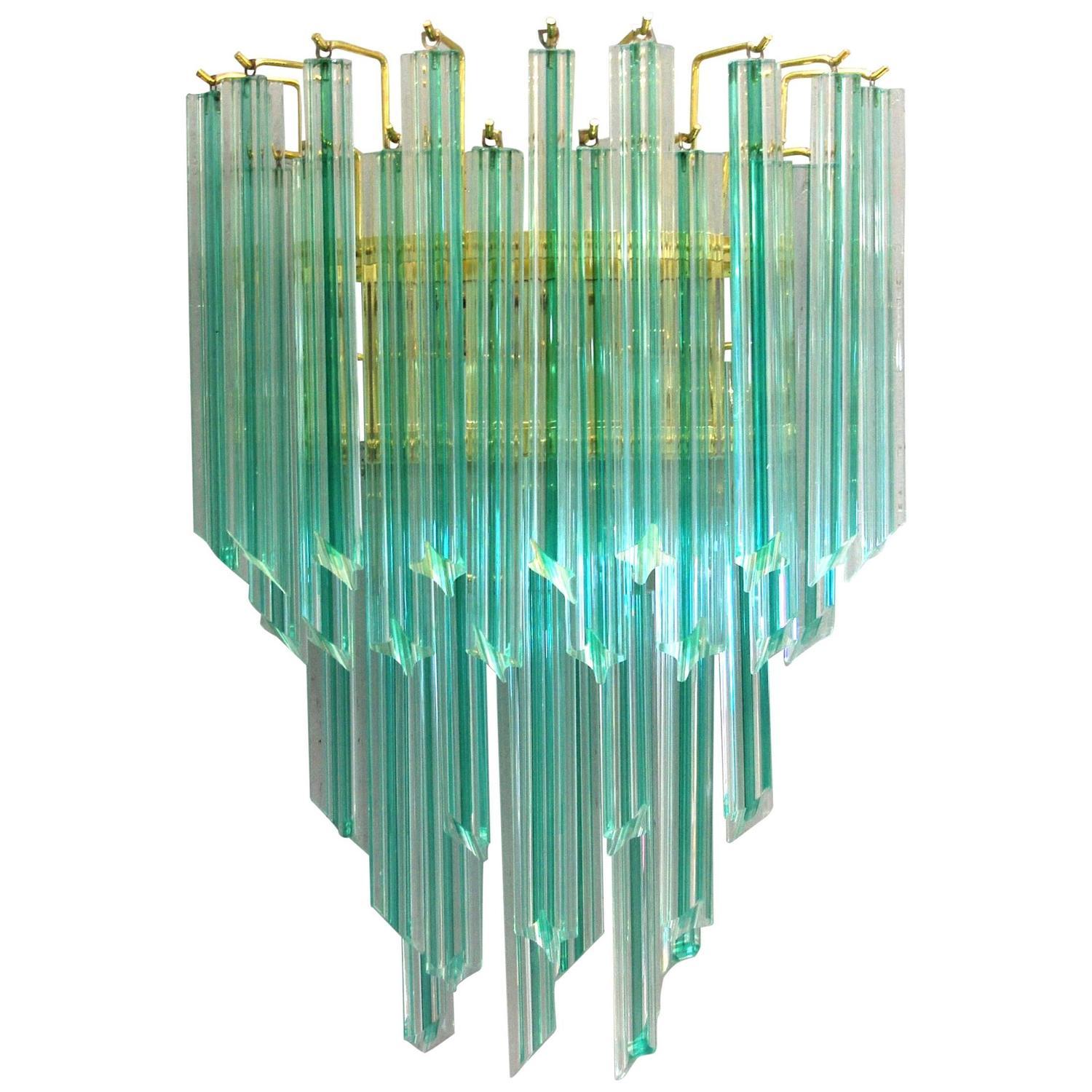 Vintage Italian wall lights with hand blown aquamarine Murano glass crystals cut into four points in Quadriedri technique, mounted on brass back plates / Designed by Venini, circa 1970’s / Made in Italy
2 lights / E12 or E14 type / max 40W