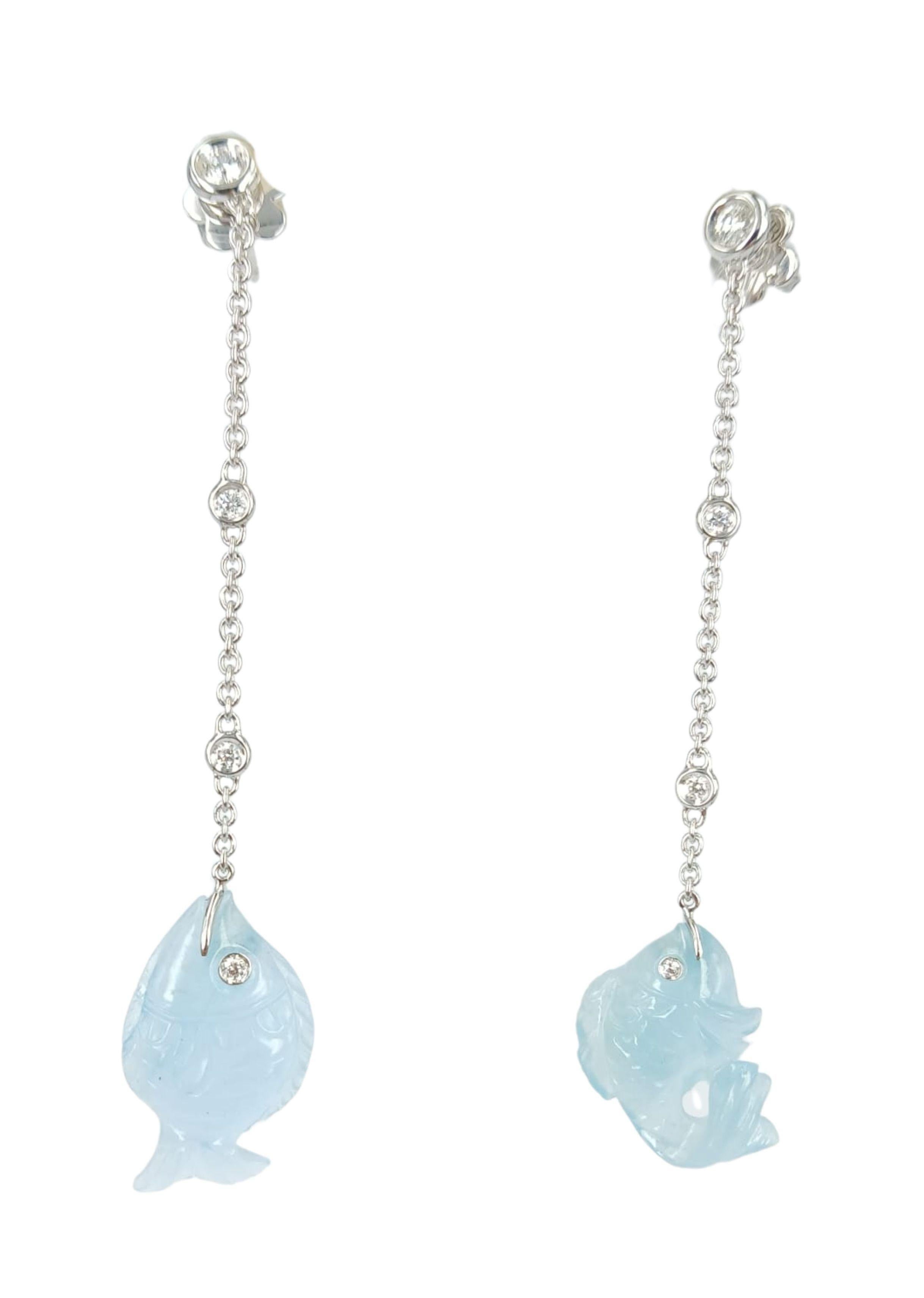 Elegant and cute long pair of earrings. 
Handmade in Italy, they feature two handcarved natural aquamarine fishes. Each one is unique, Please note that the back part has one diamonds and, ONE ONLY FISH HAS A MARK;  BUT IT IS A NATURAL PART OF THE