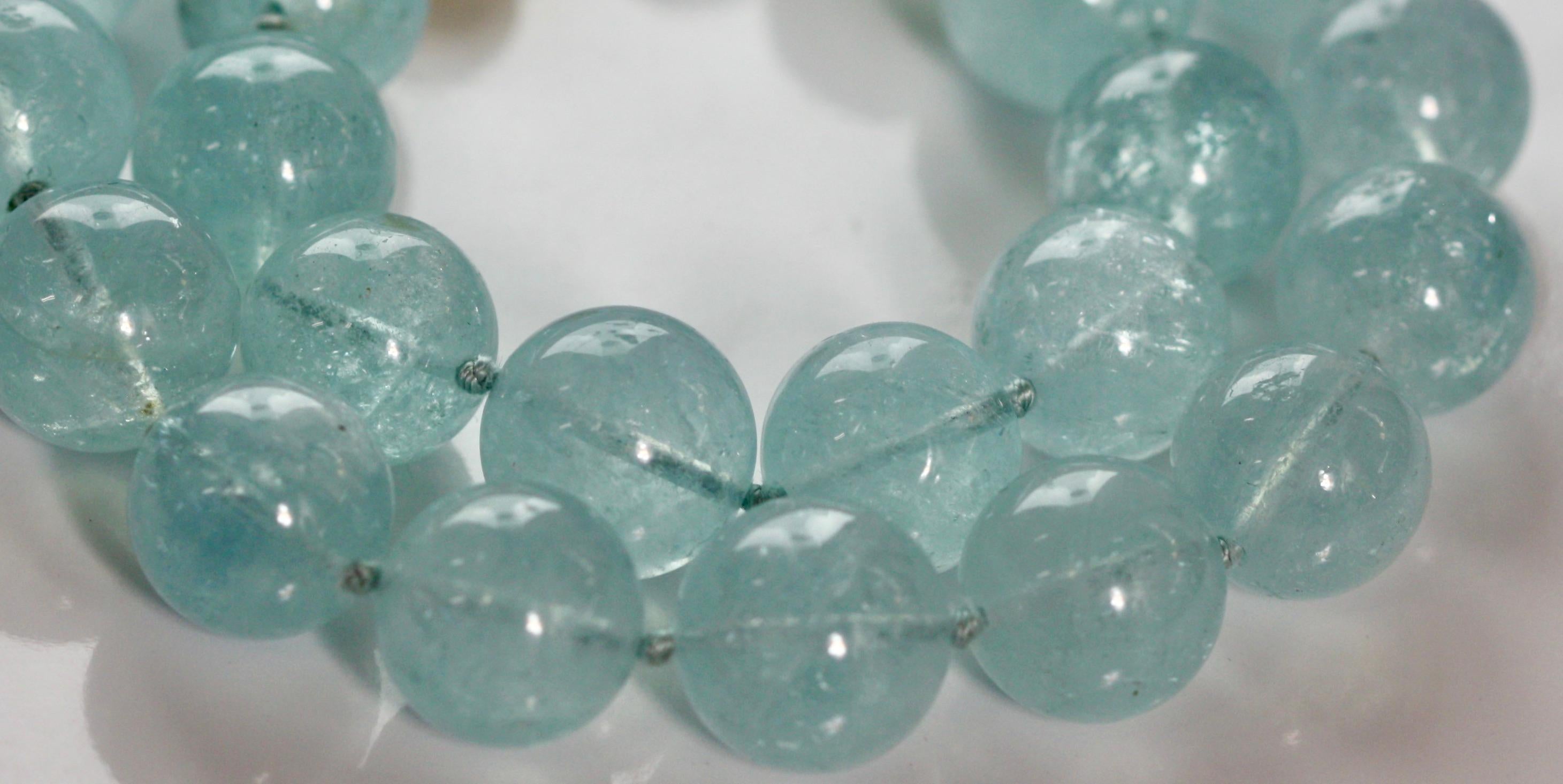 
Aquamarine Necklace
Designed as a row of aquamarine spheres measuring approximately 16mm, 
to a spherical magnetic clasp, length approximately 18 inches.