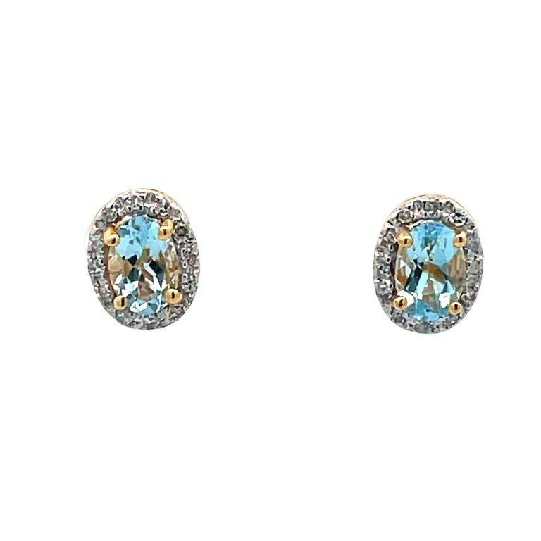 This pair of earrings are made of two oval aquamarine color stones with a total weight of 0.60 carats selected for their clarity and brilliance. These beautiful aquamarine earrings are made also with a single row of round white diamonds with a total