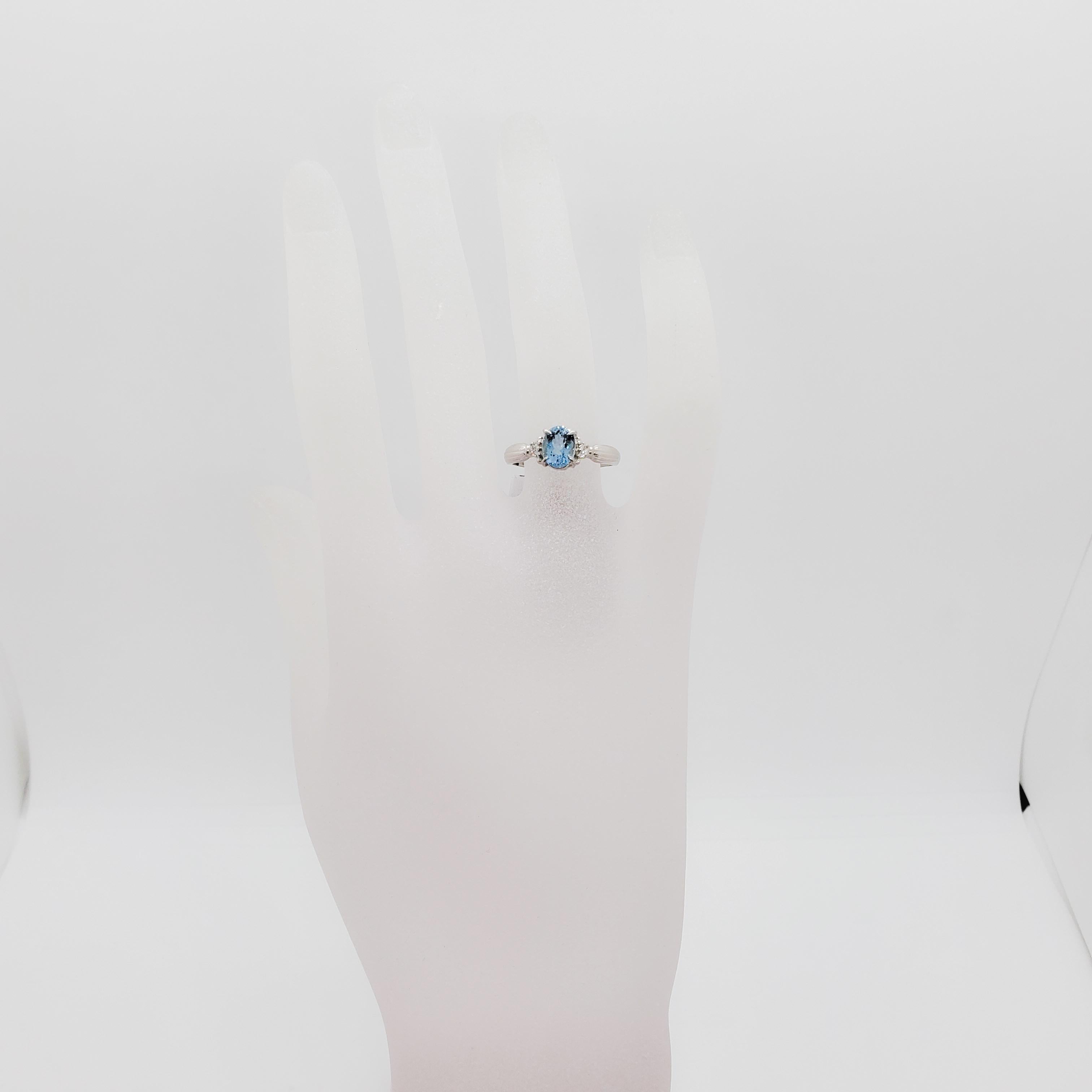 Beautiful 0.90 ct. aquamarine oval with 0.04 ct. of white diamond rounds.  Handmade platinum mounting.  Ring size 5.75.  
