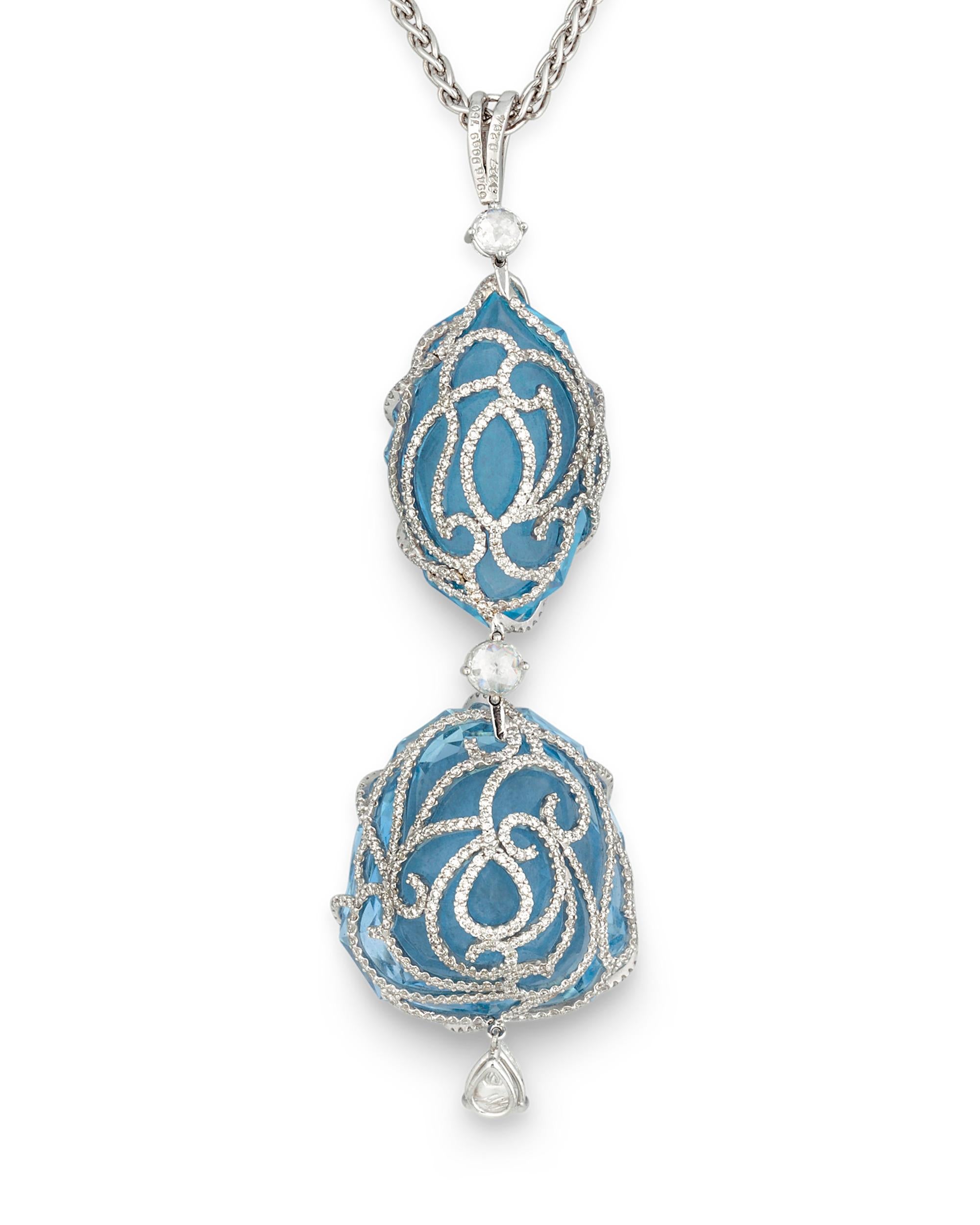 Two incredible aquamarines showcase their ice-blue hue in this 18K white gold pendant necklace by jewelry designer, Michael Youssoufian. The gems are cut into modified shield and modified marquise cuts, giving them the impression of droplets of