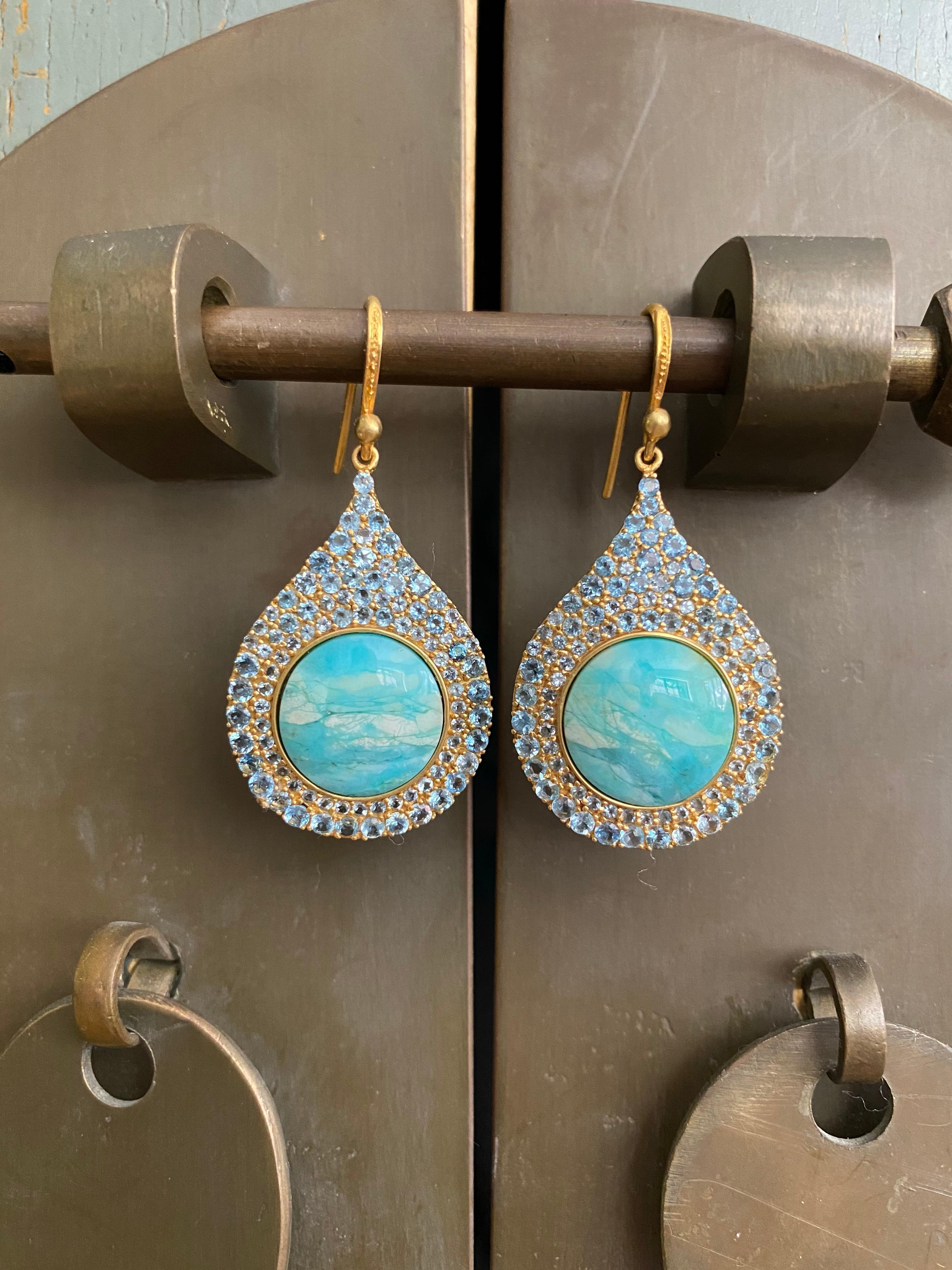 Designed by award winning jewelry designer, Lauren Harper, these earrings have 3.93cts of stunning faceted Aquamarines that surround beautiful ocean-toned Petrified Opalized Wood pieces in a perfect teardrop shape. You will find these earrings match