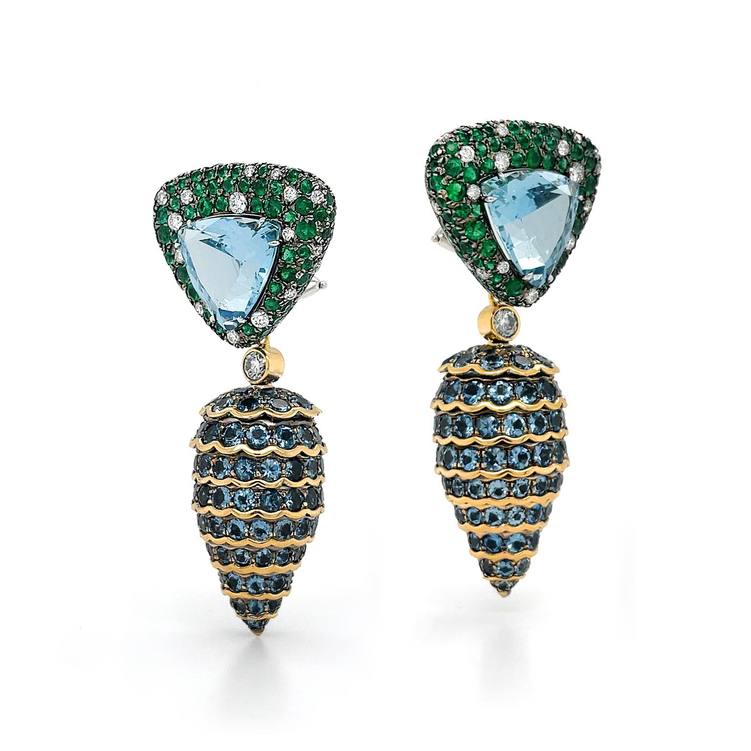 A trio of jewels create these versatile pine cone earrings. Beginning with a triangle pointed downward, a trillion-cut aquamarine beams in the center as emeralds with dispersed brilliant cut diamonds surround it. Next, a single diamond bezel set in