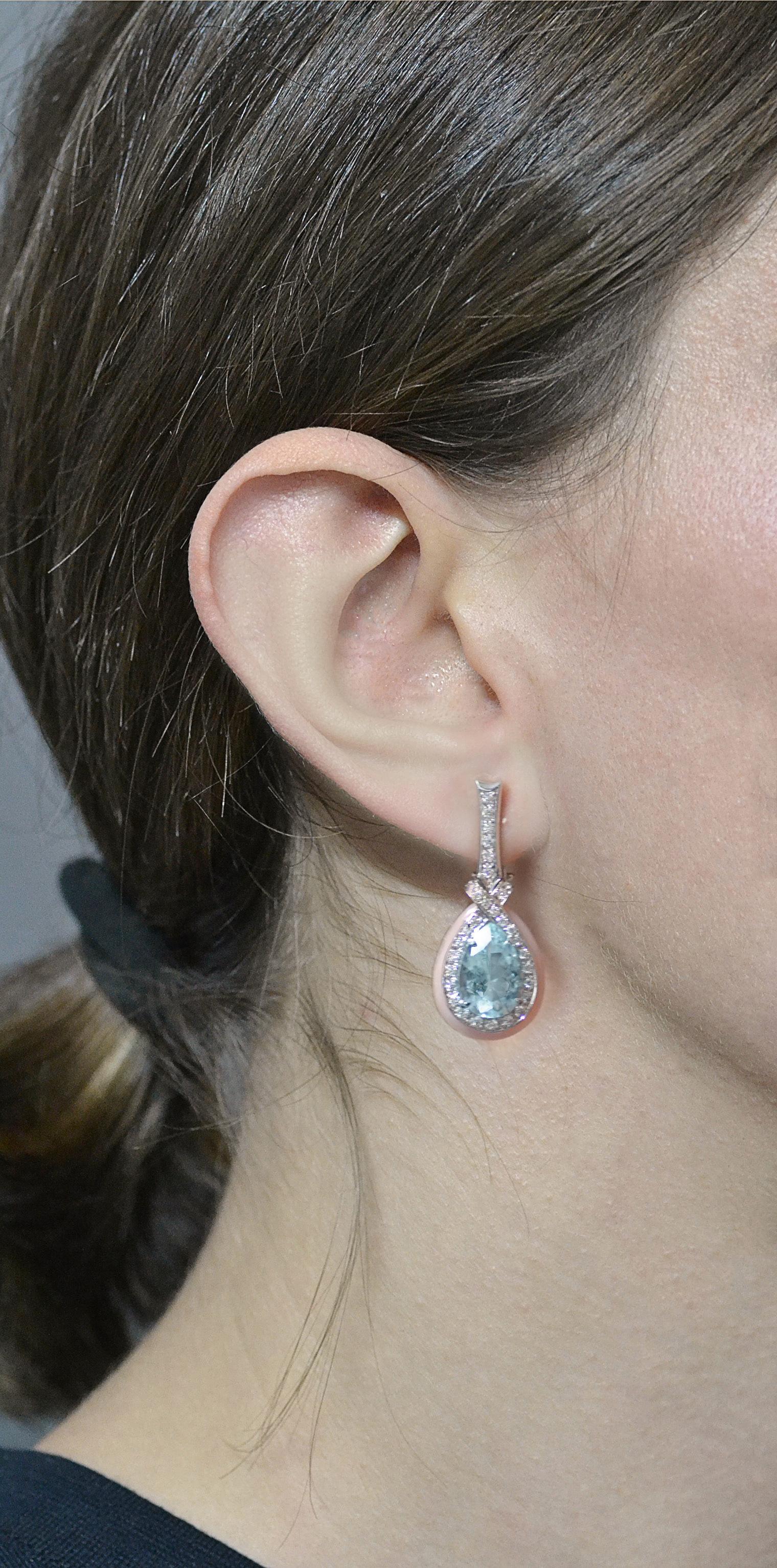 Handcrafted in Italy in Margherita Burgener family workshop, the earrings are centering two aquamarine drops framed by a line of diamonds surrounded by inserts of pink opals. 
Suspended by a line of diamonds set on white gold, the earrings features