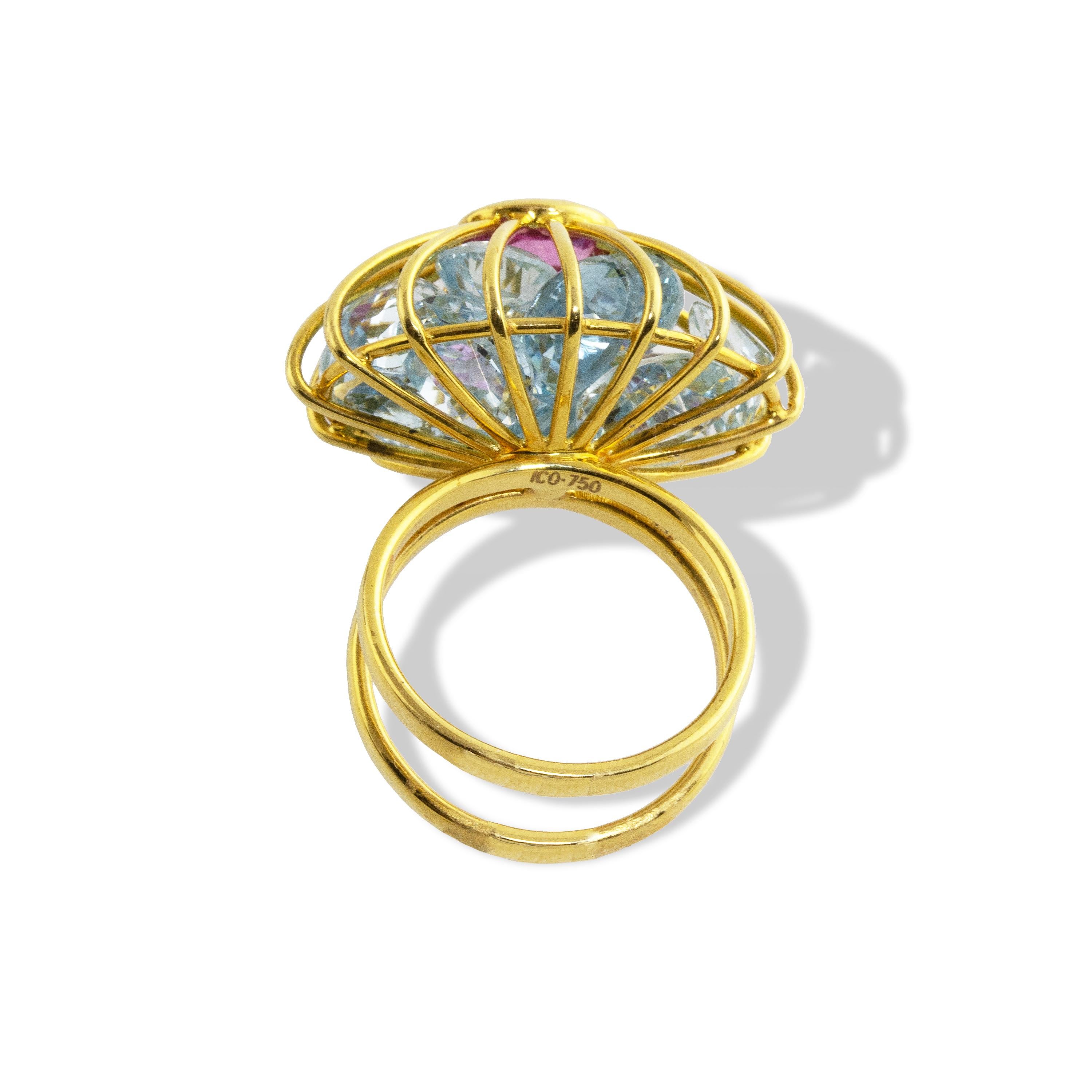 This one-of-a-kind ring features Aquamarine Cage ring features 21.5 carats of Aquamarine with a 2 1/2 carat Rubellite Tourmaline center gemstone.  
Stones are loose inside , moving to catch the light in an amazing way.  
The ring is finished with a