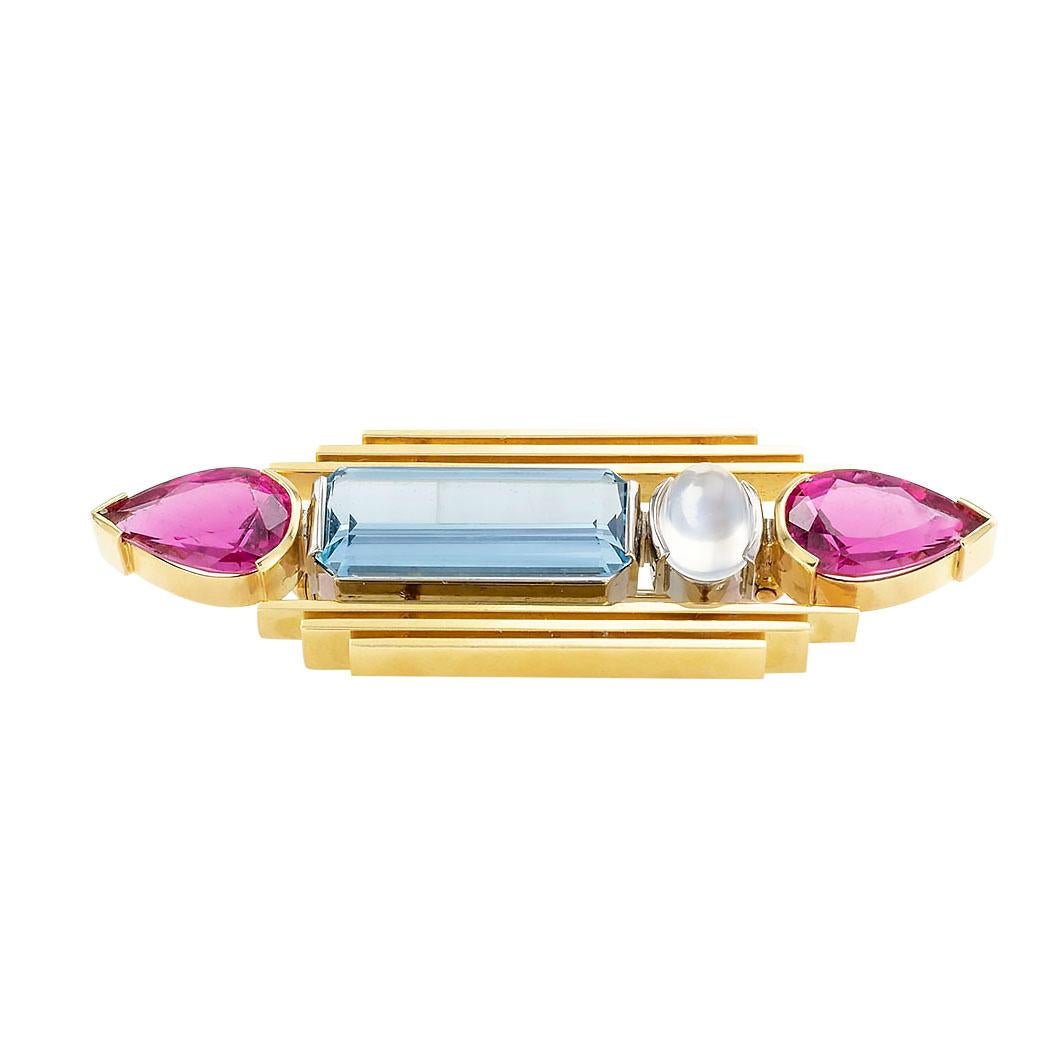 Aquamarine, moonstone, pink tourmaline, and yellow gold bar brooch circa 1970.             This is a handmade one of a kind brooch.

The facts you want to know are listed below.  Read on.  It is all remarkably short, simple, and clear.

Contact us