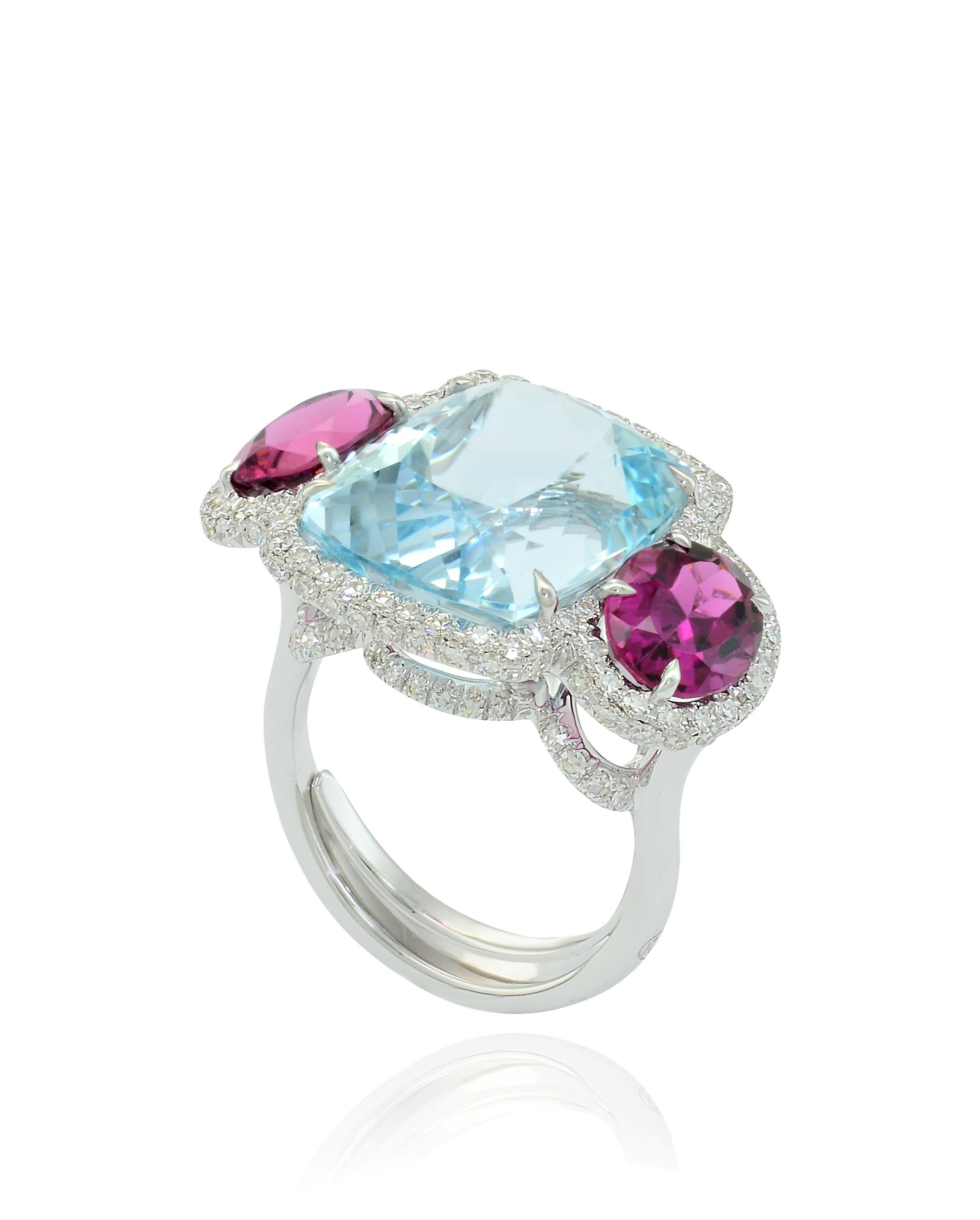 Enchanting 3 stones ring, handcrafted in Italy, in Margherita Burgener workshop.

aquamarine total ct 14.44
2 oval natural pink tourmalines  ct 3.82
18 kt white gold  grams 9.23 
129 diamonds  total carat 1.02

US Size US 6¾ - European size 53